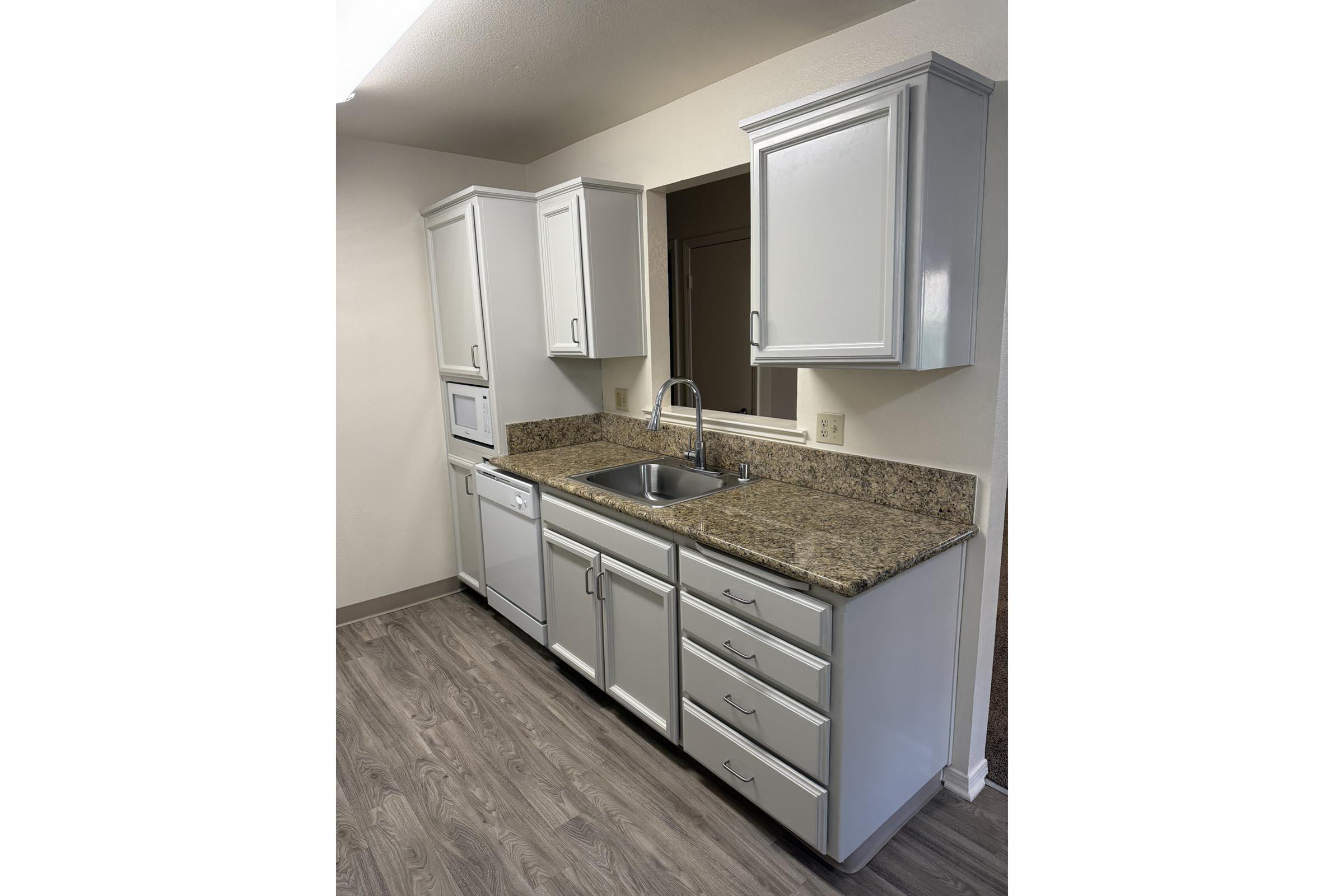 a kitchen with a sink and a mirror