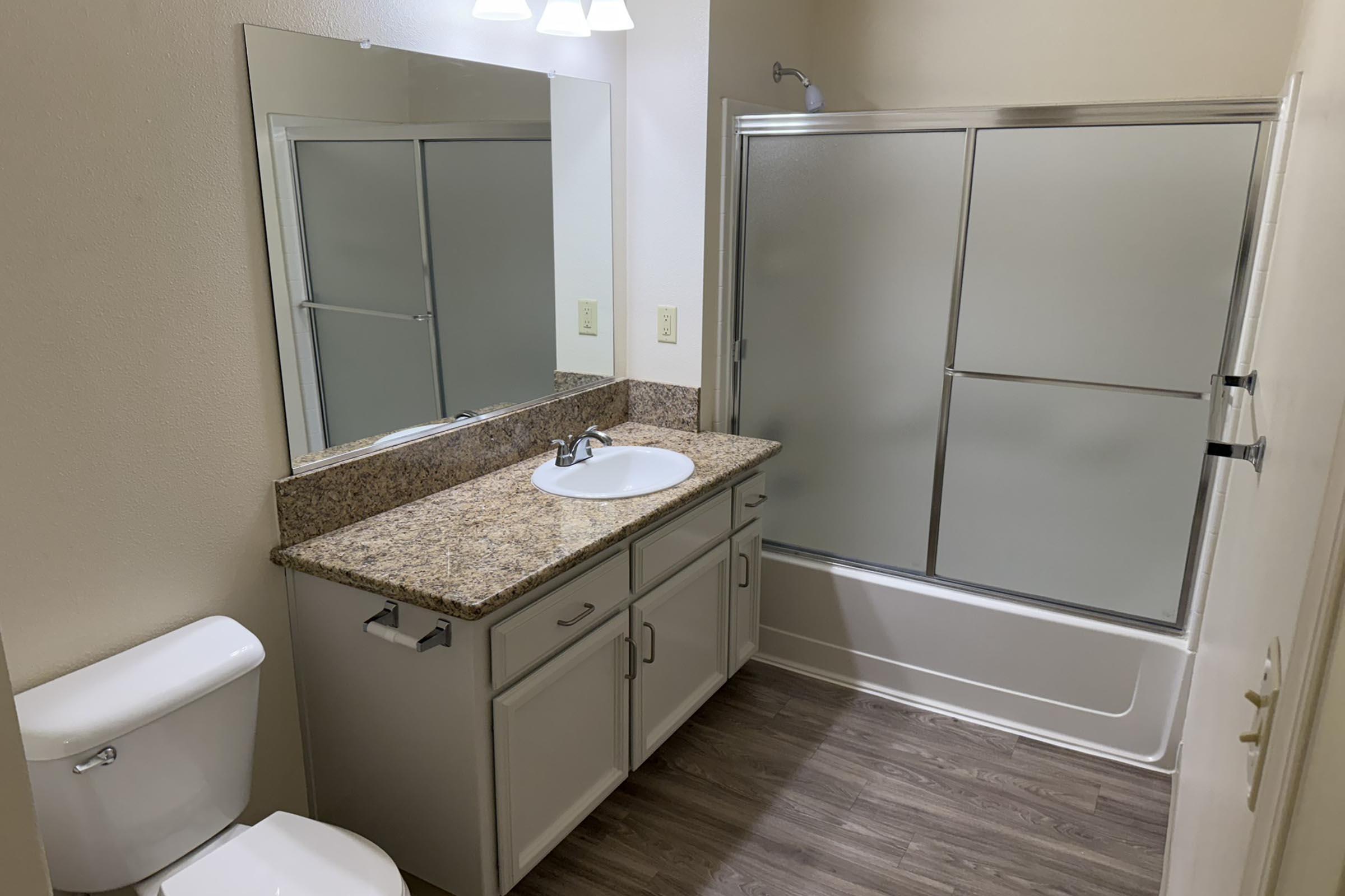 a bedroom area with a sink and a mirror