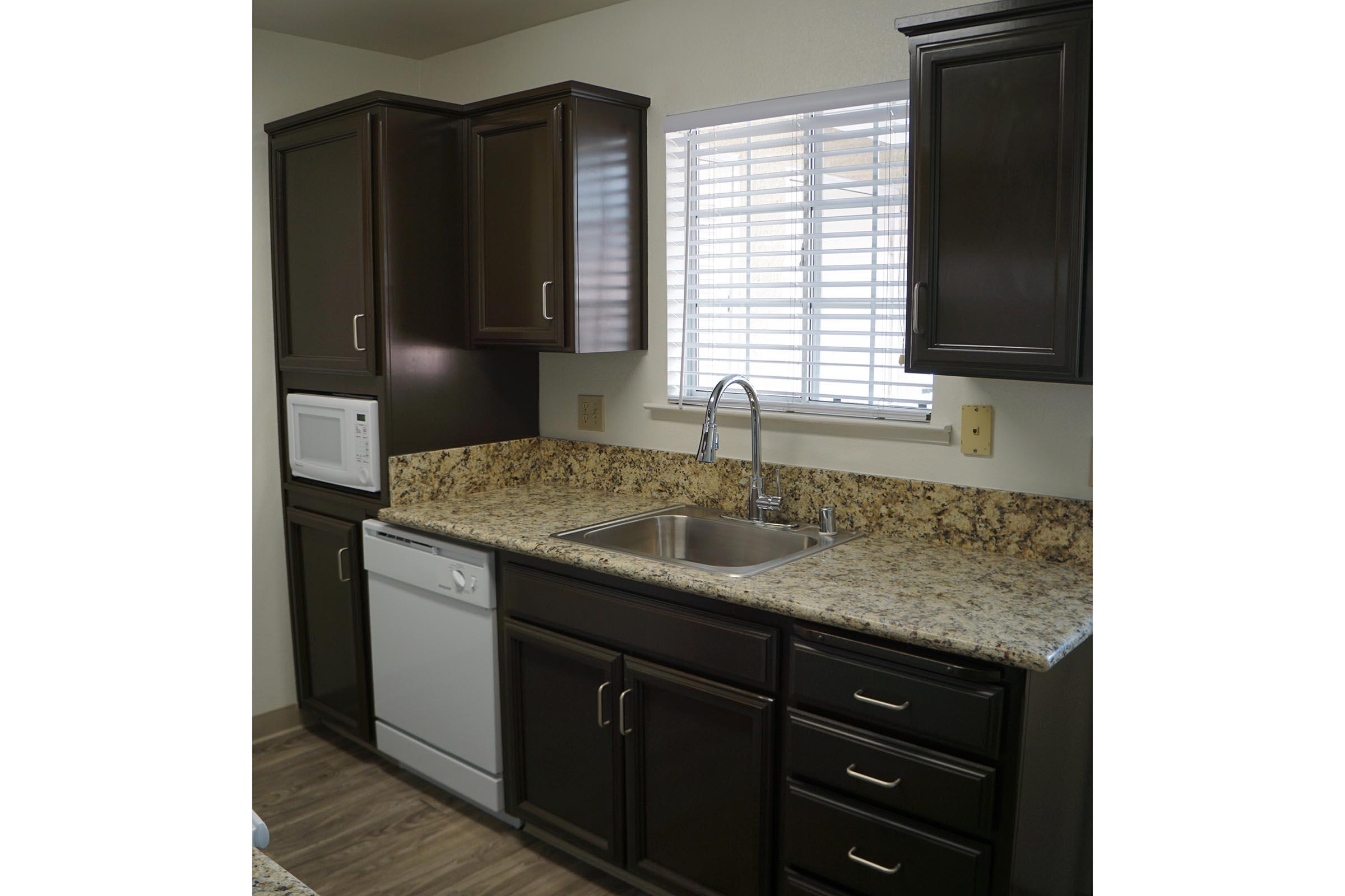 a kitchen with a sink and a microwave