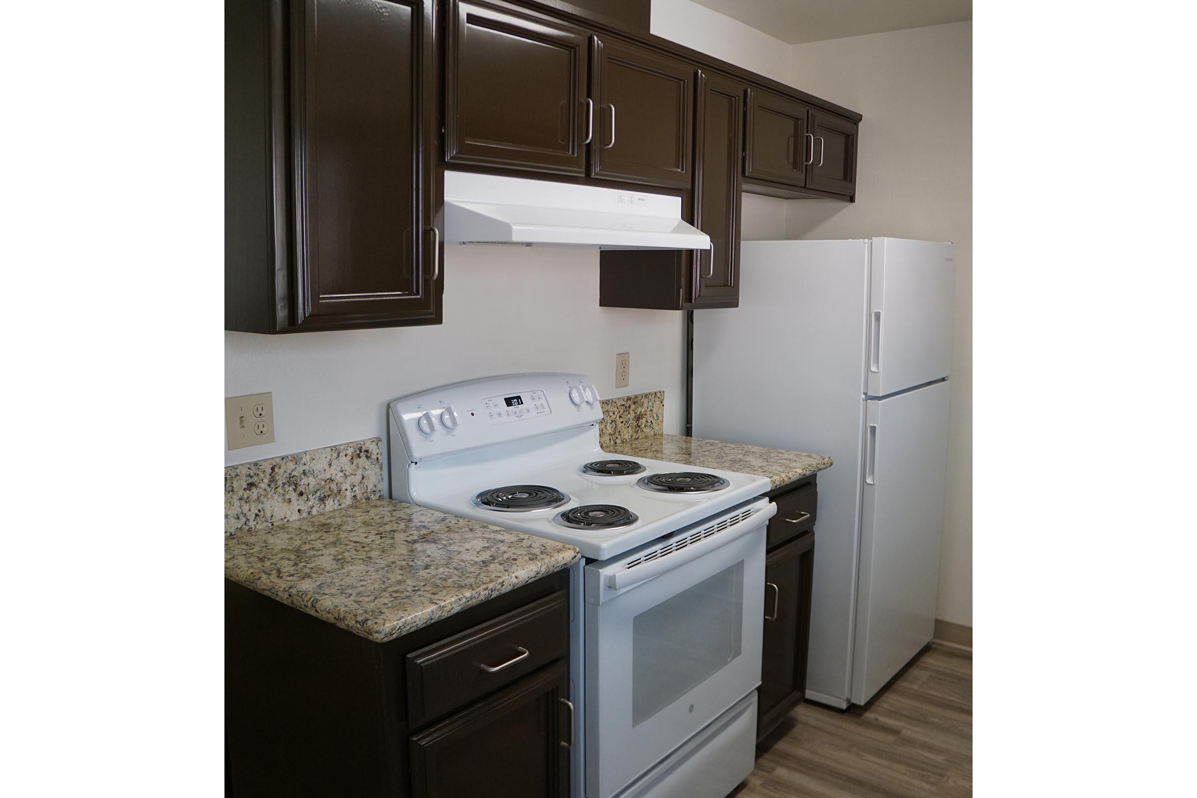 a kitchen with a stove sink and refrigerator