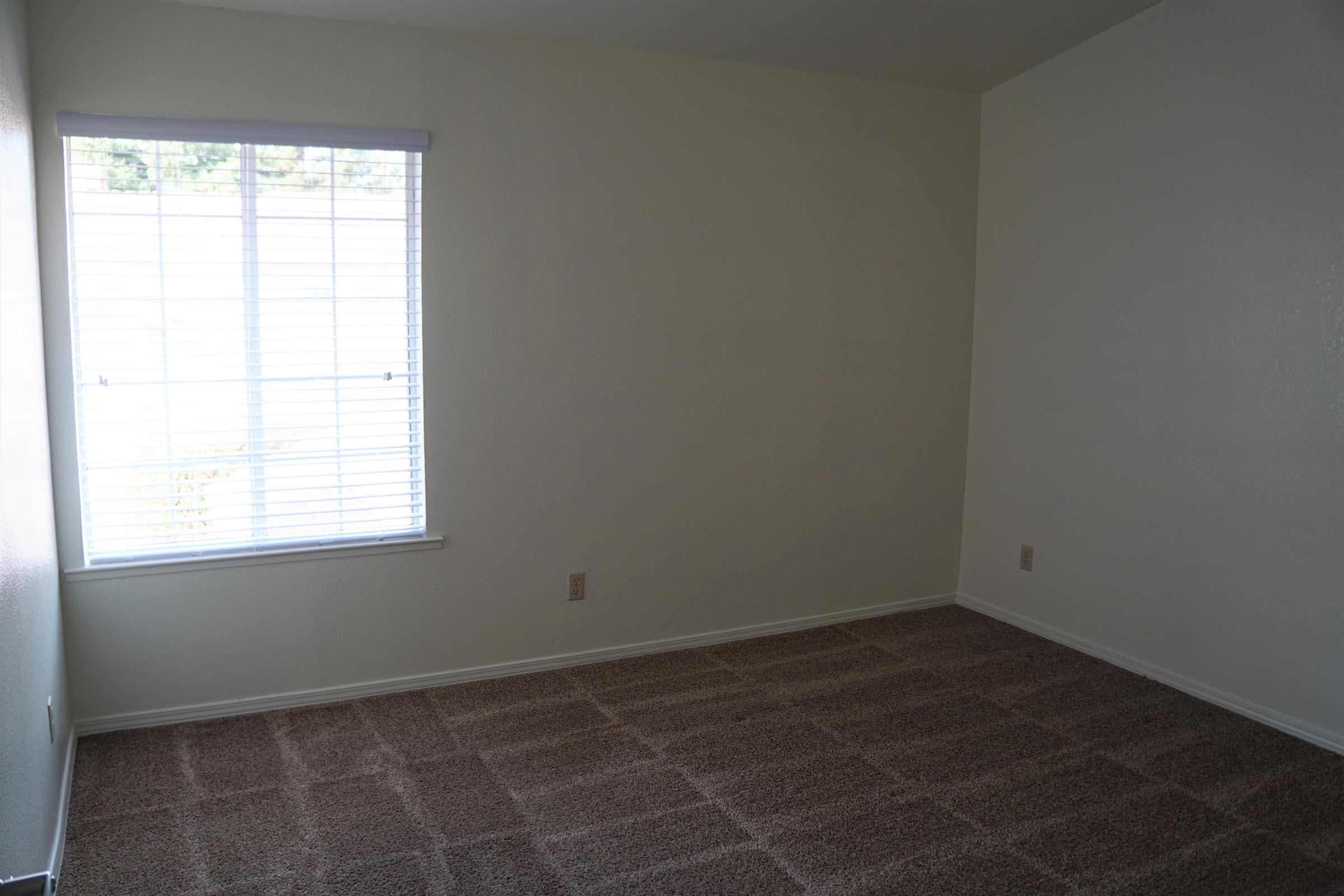 a bedroom with a large window