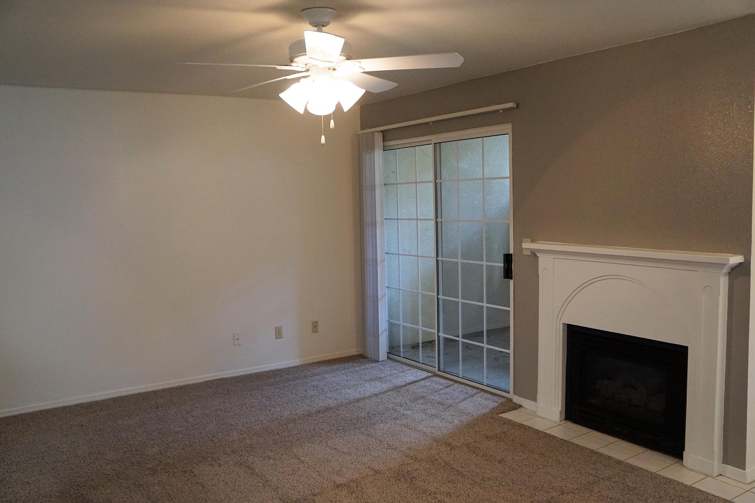 a room with a fireplace and a large window