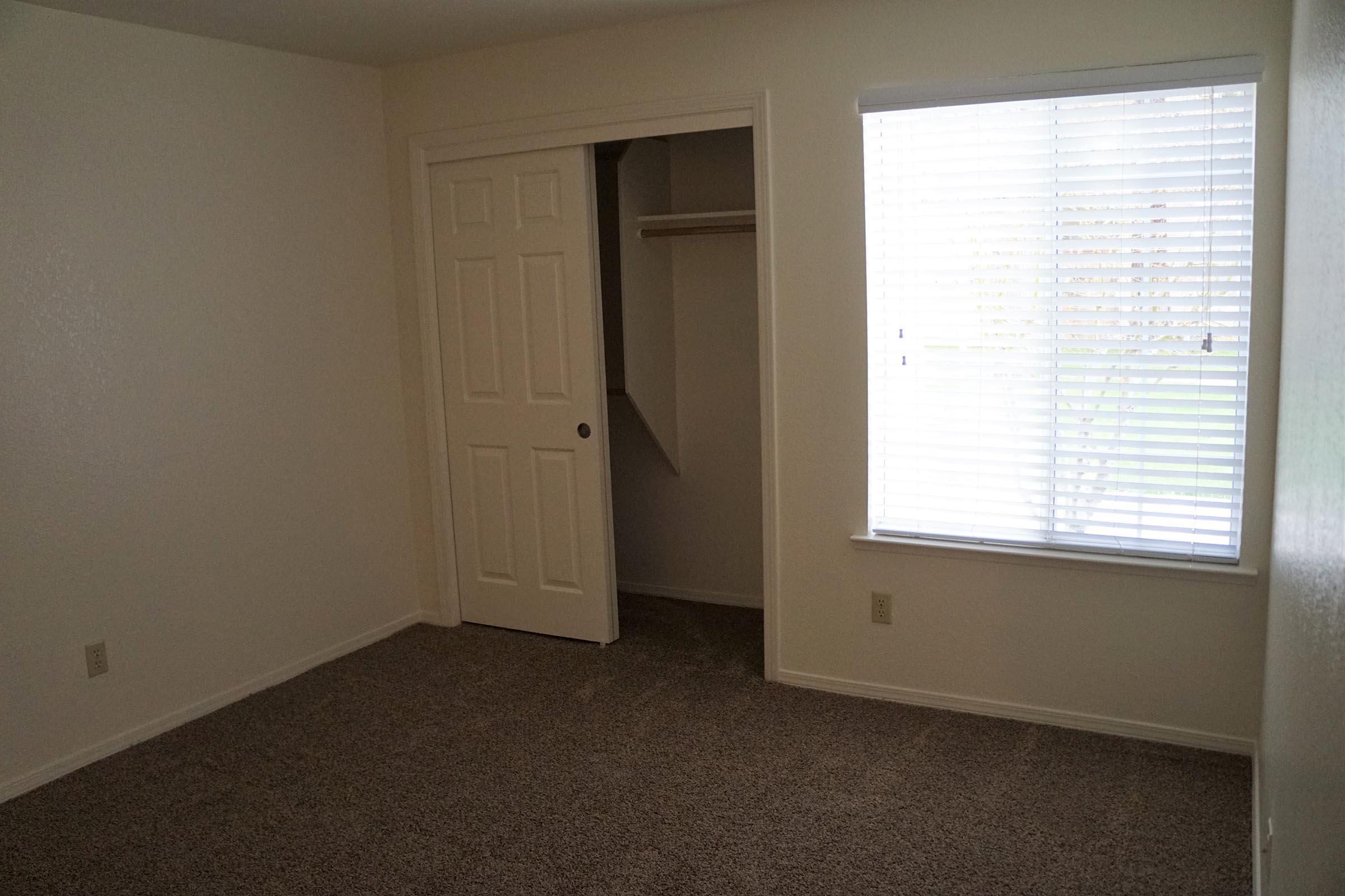 a bedroom with a large window