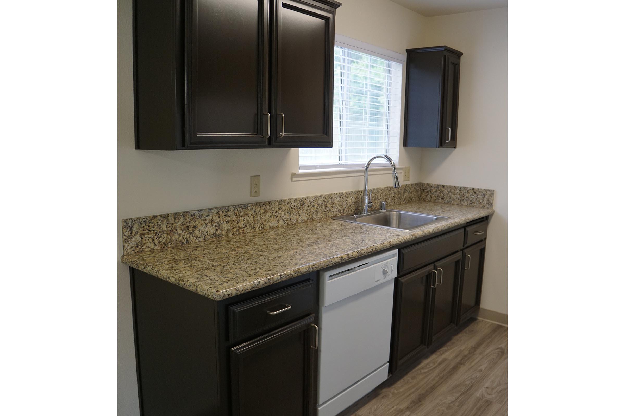 a kitchen with a sink and a mirror