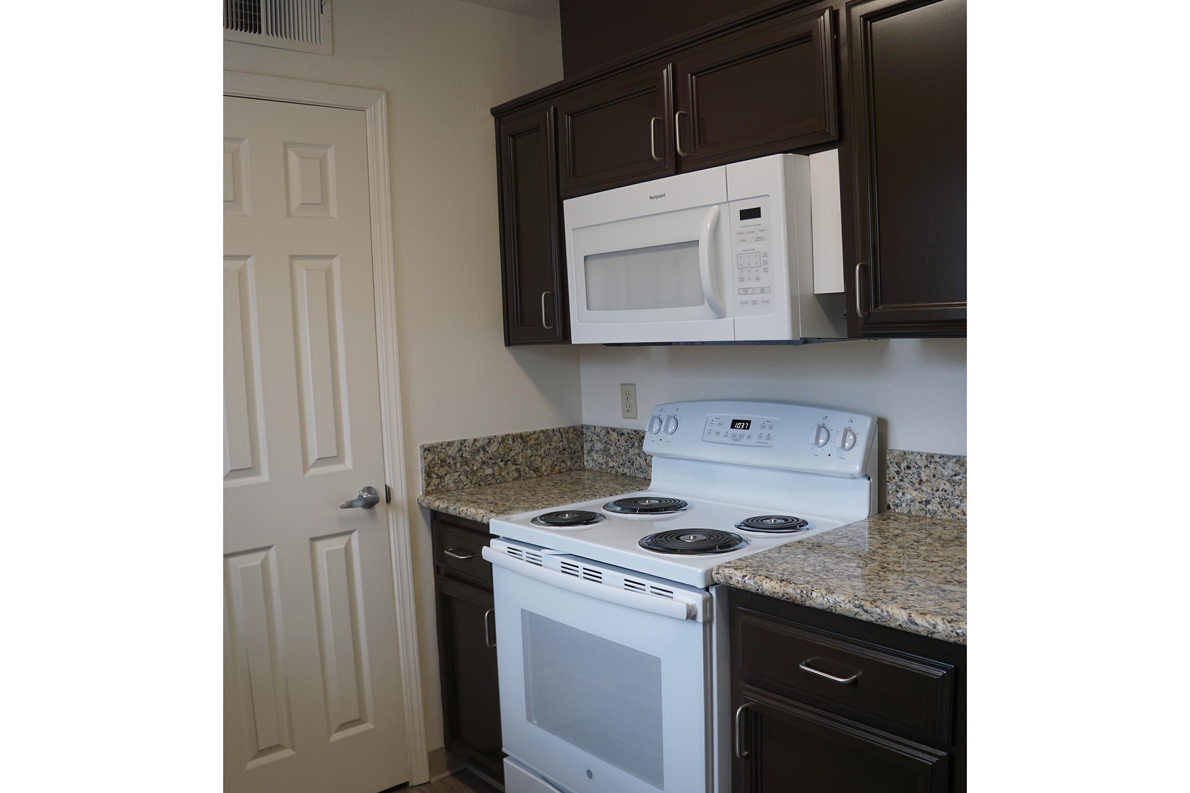 a stove top oven sitting inside of a kitchen