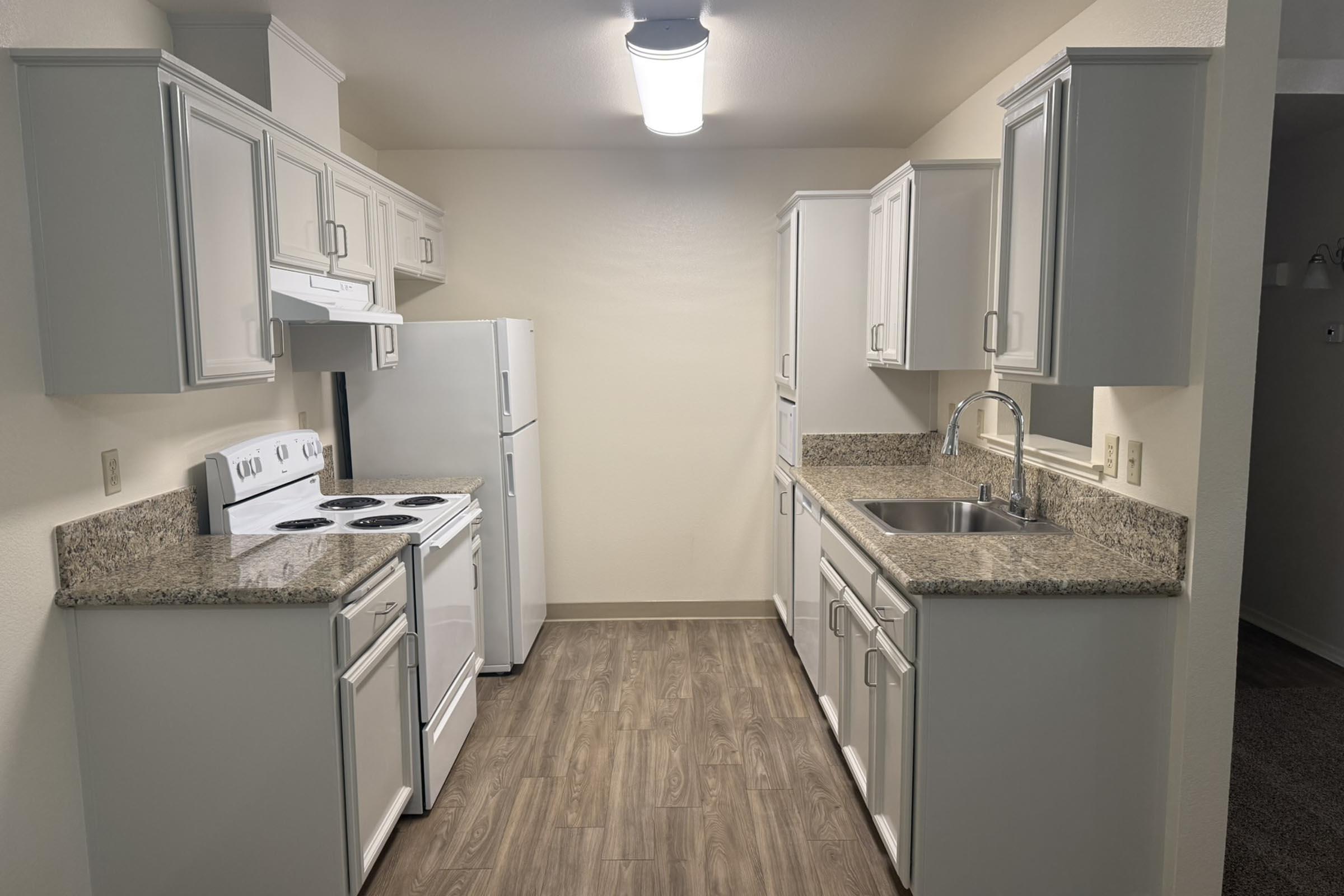 a kitchen with a sink and a mirror