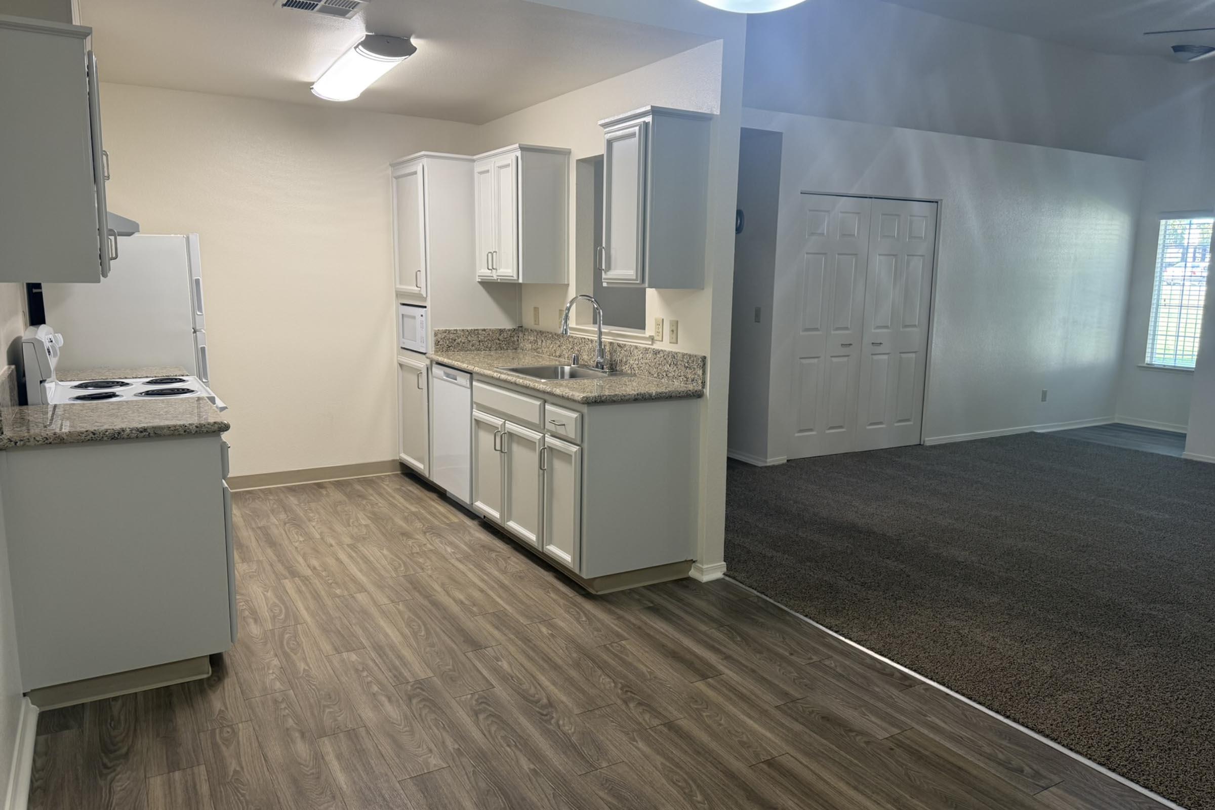 a room with a sink and a refrigerator