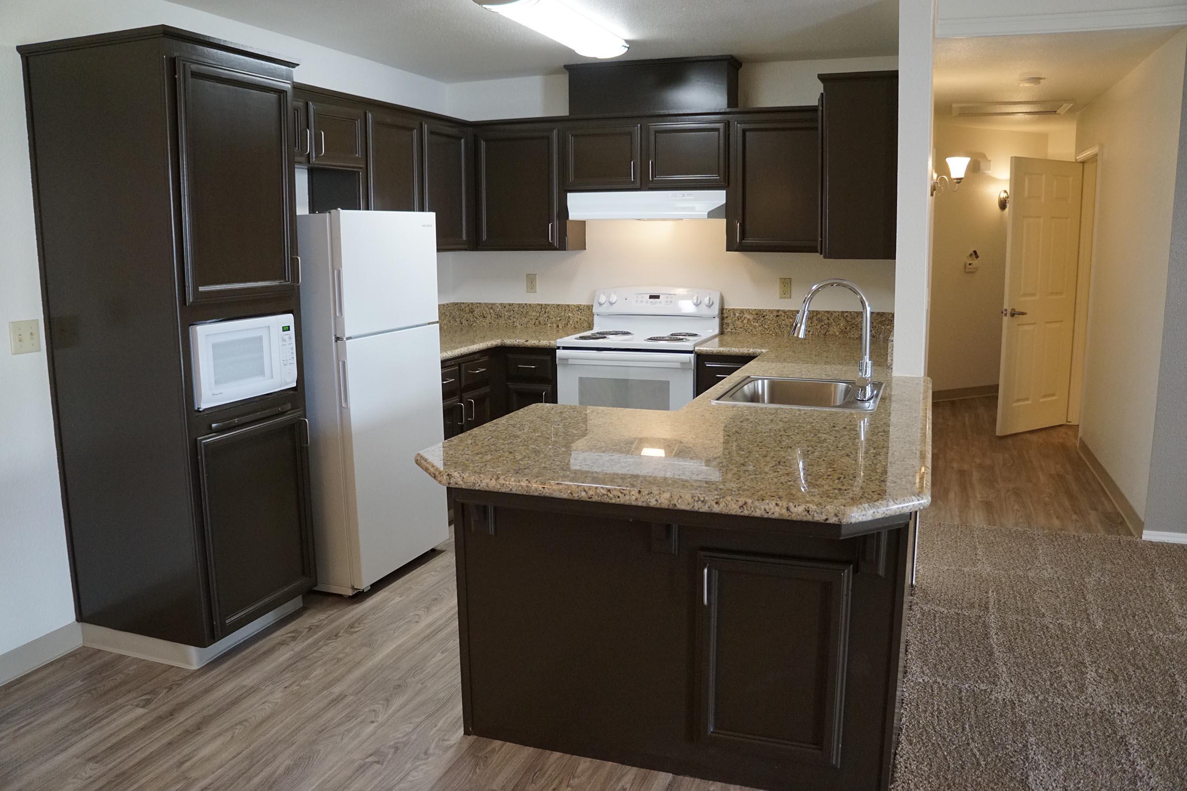 a kitchen with a sink and a refrigerator