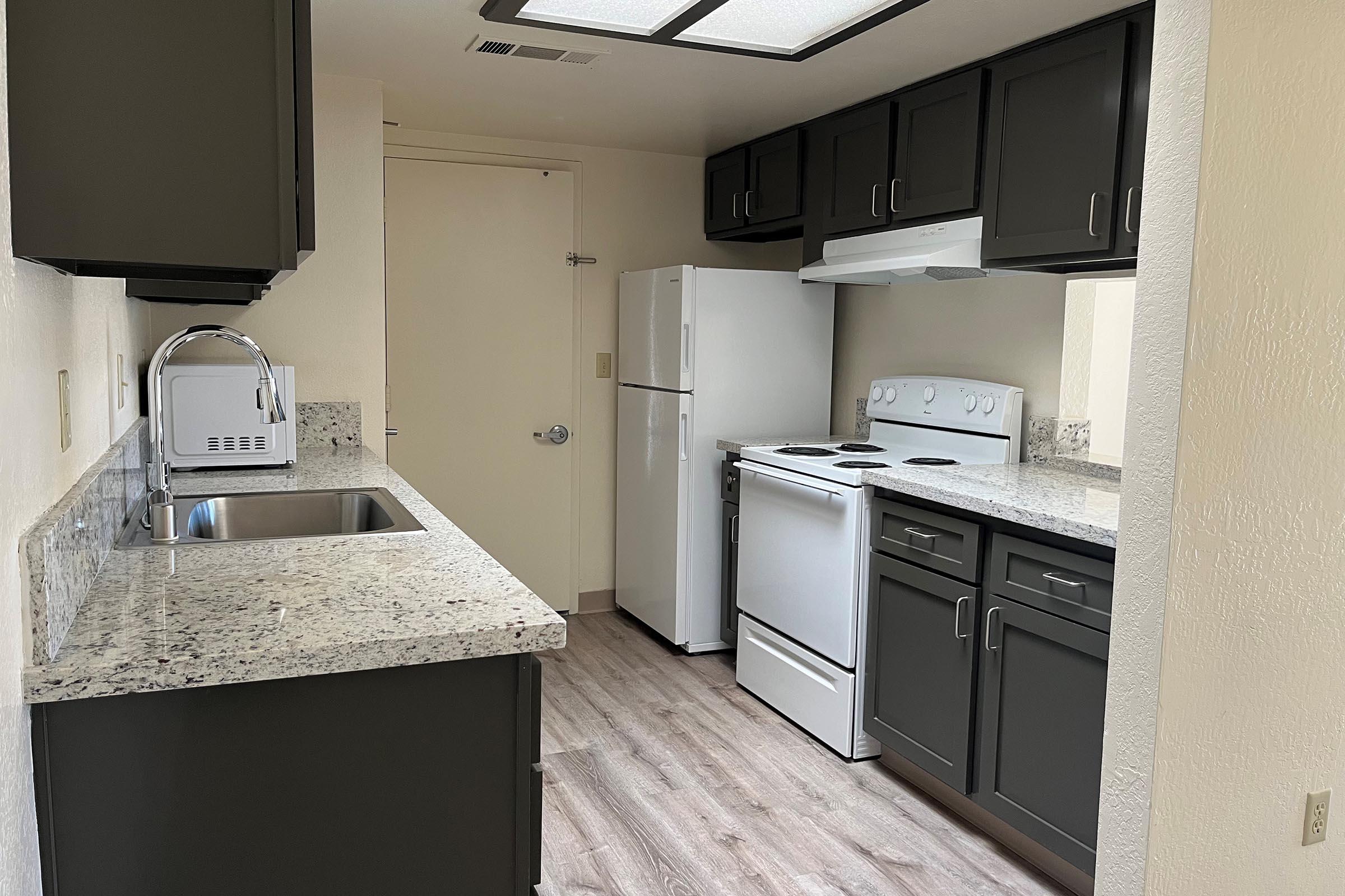 a kitchen with a sink and a refrigerator