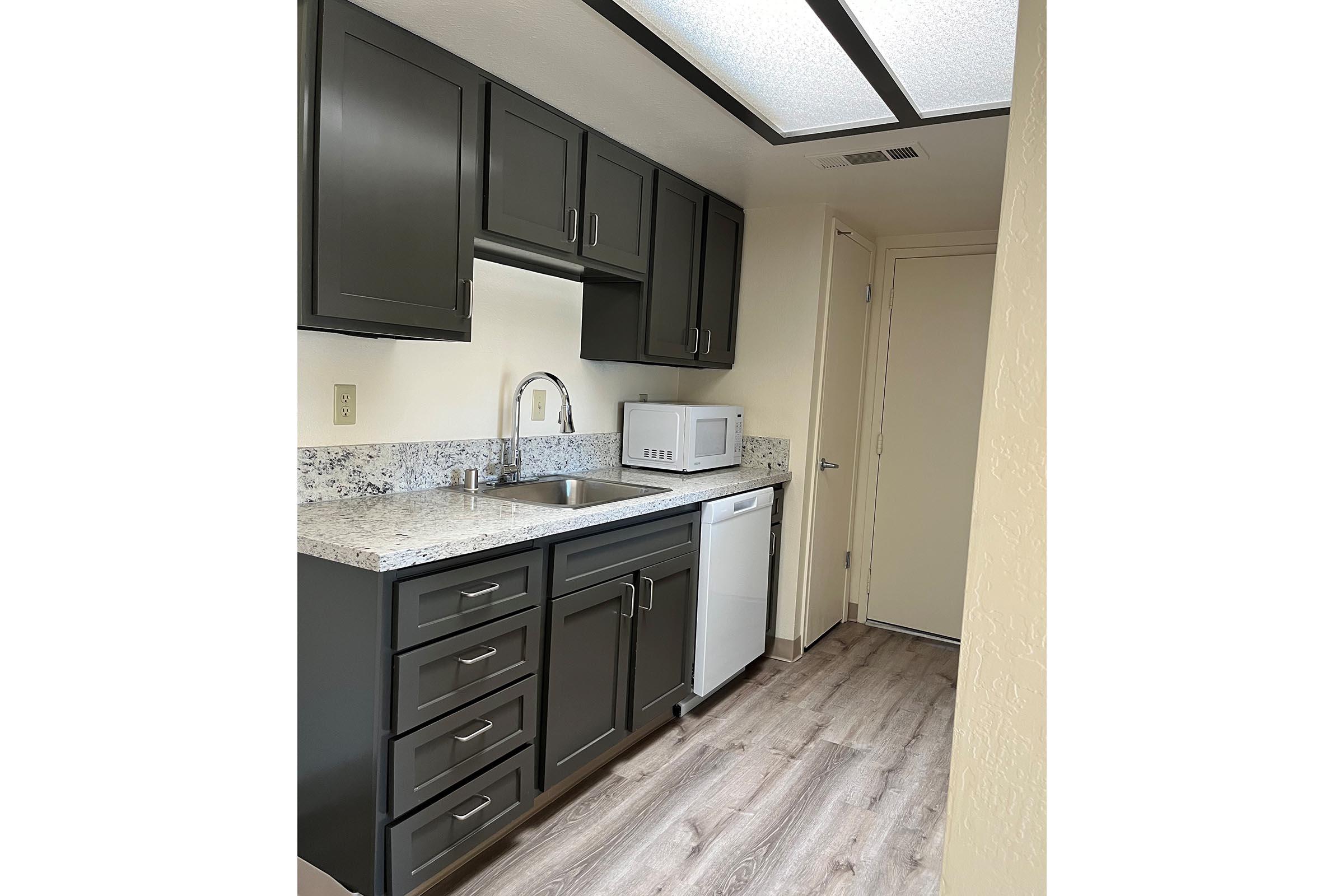 a kitchen with a sink and a mirror