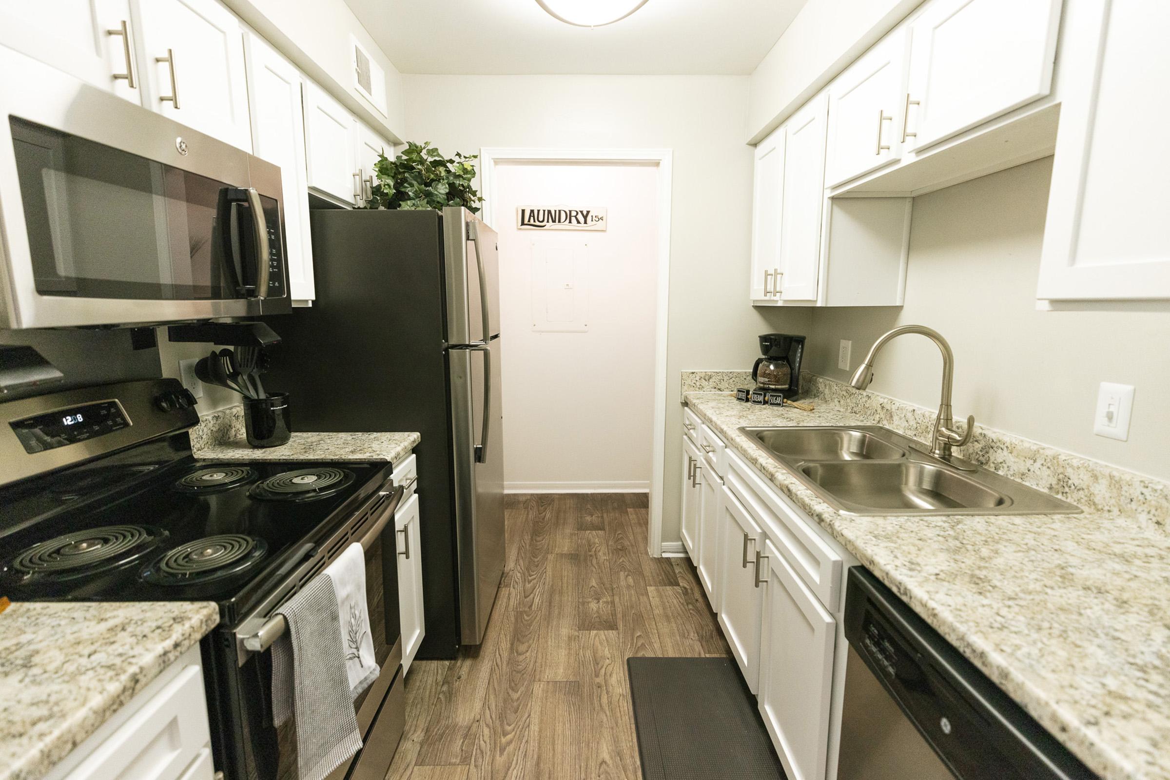 a kitchen with a stove a sink and a microwave