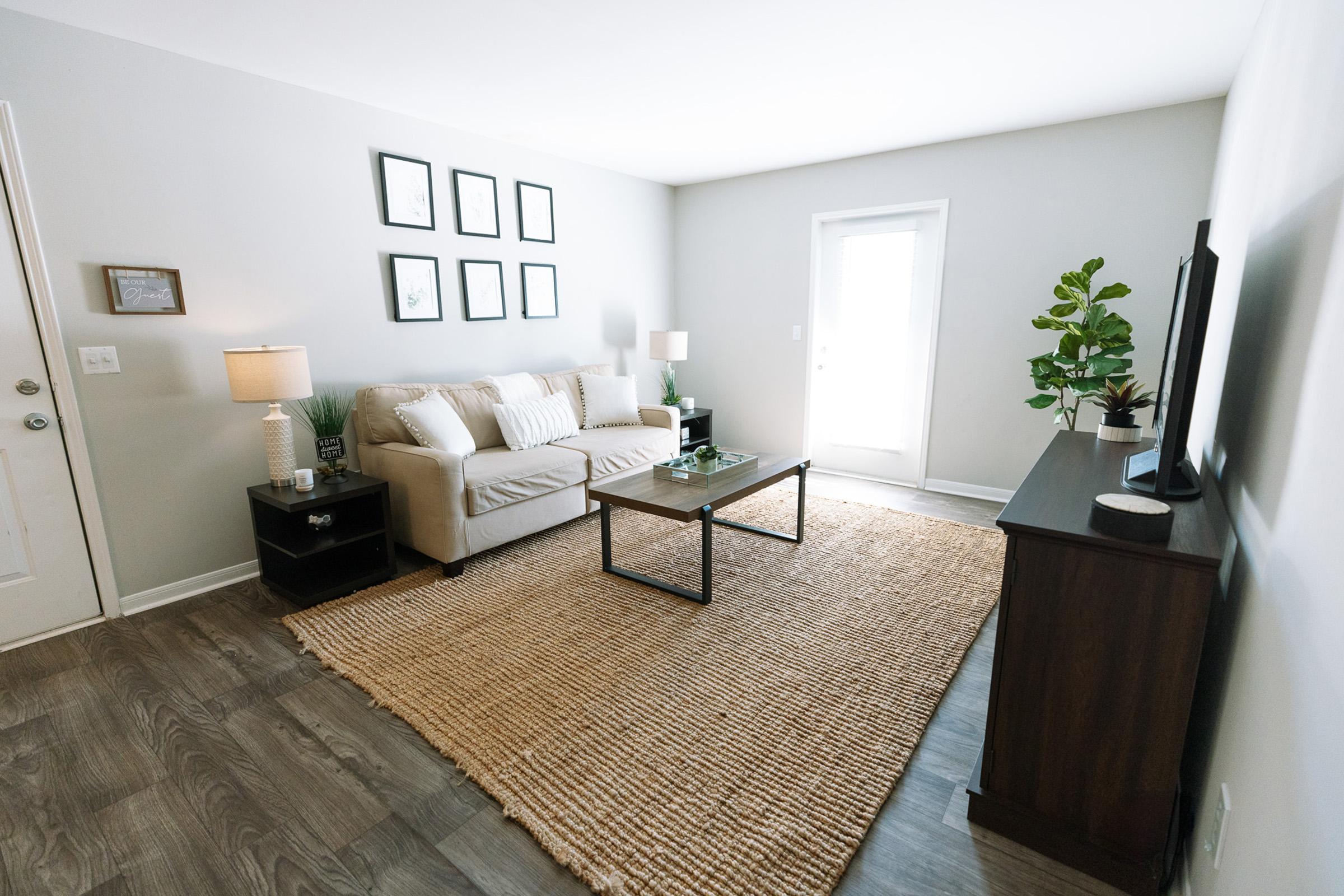 a bedroom with a bed and a chair in a room