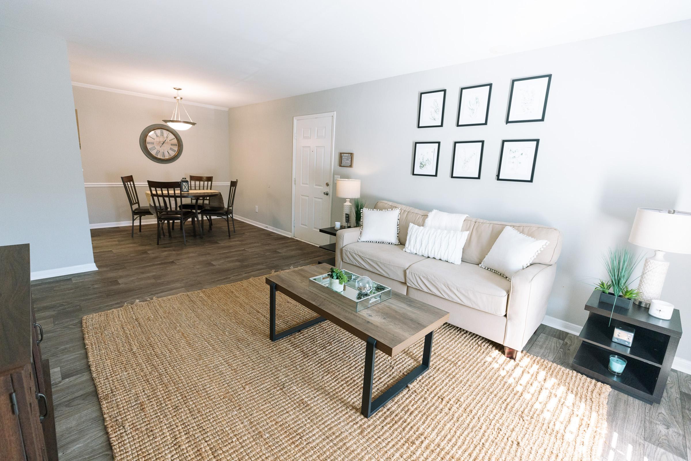 a living room filled with furniture and a rug