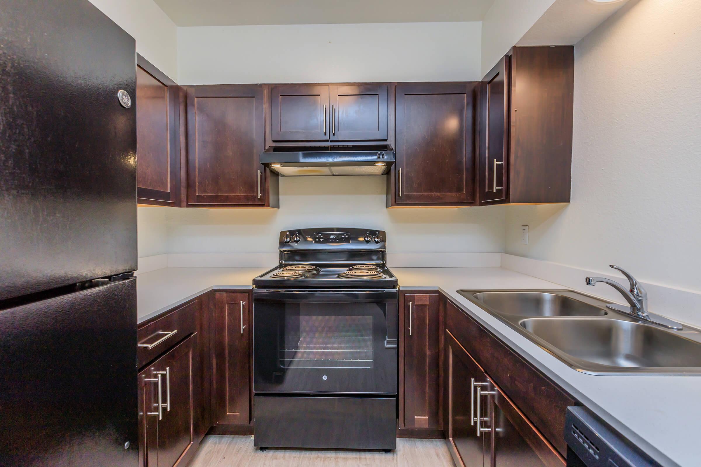 a kitchen with stainless steel appliances and wooden cabinets