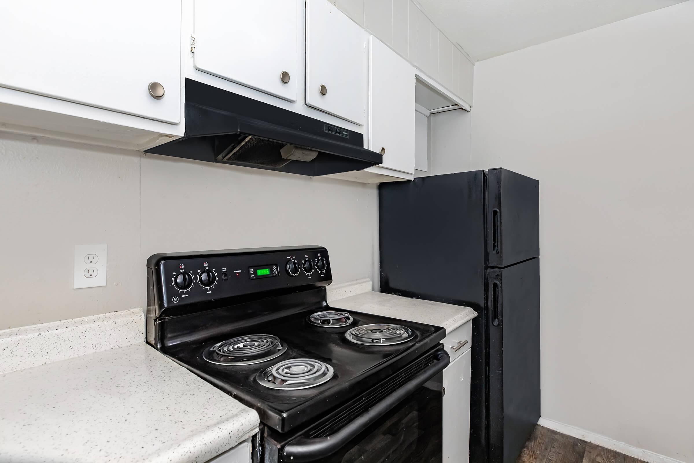 a stove top oven sitting inside of a kitchen