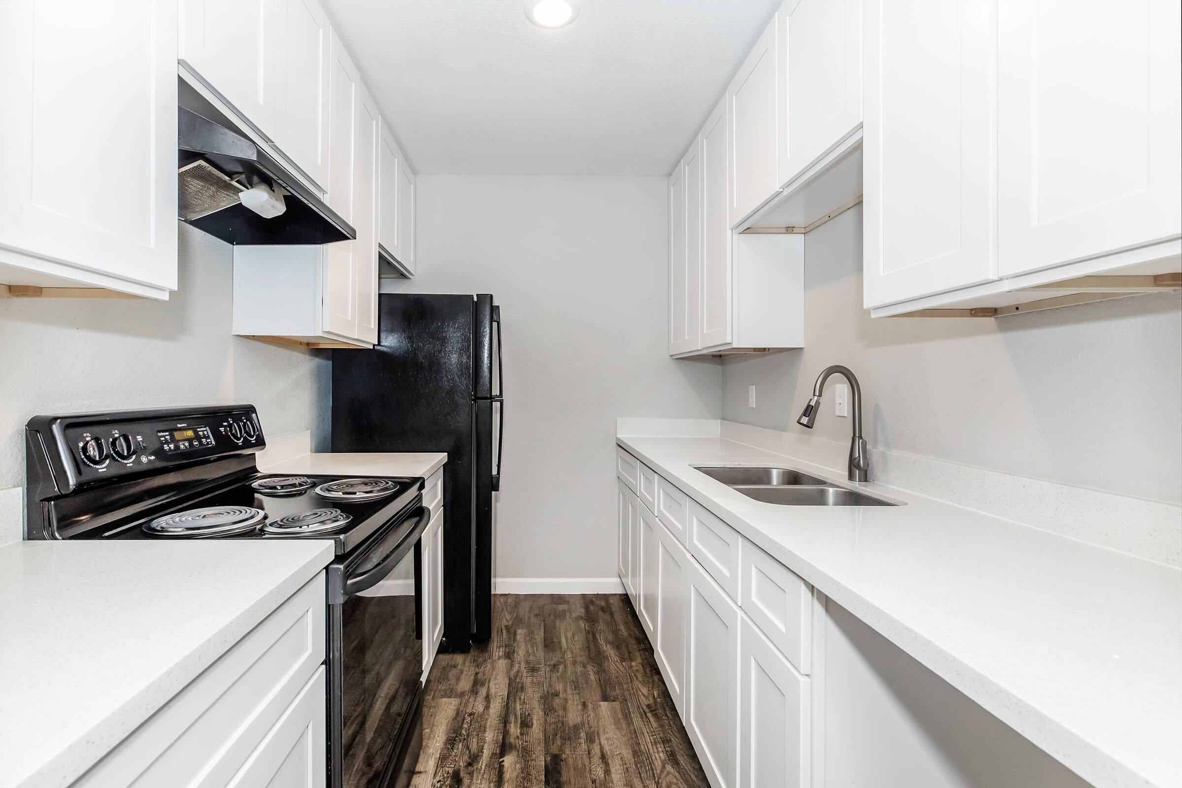 a kitchen with a stove and a sink