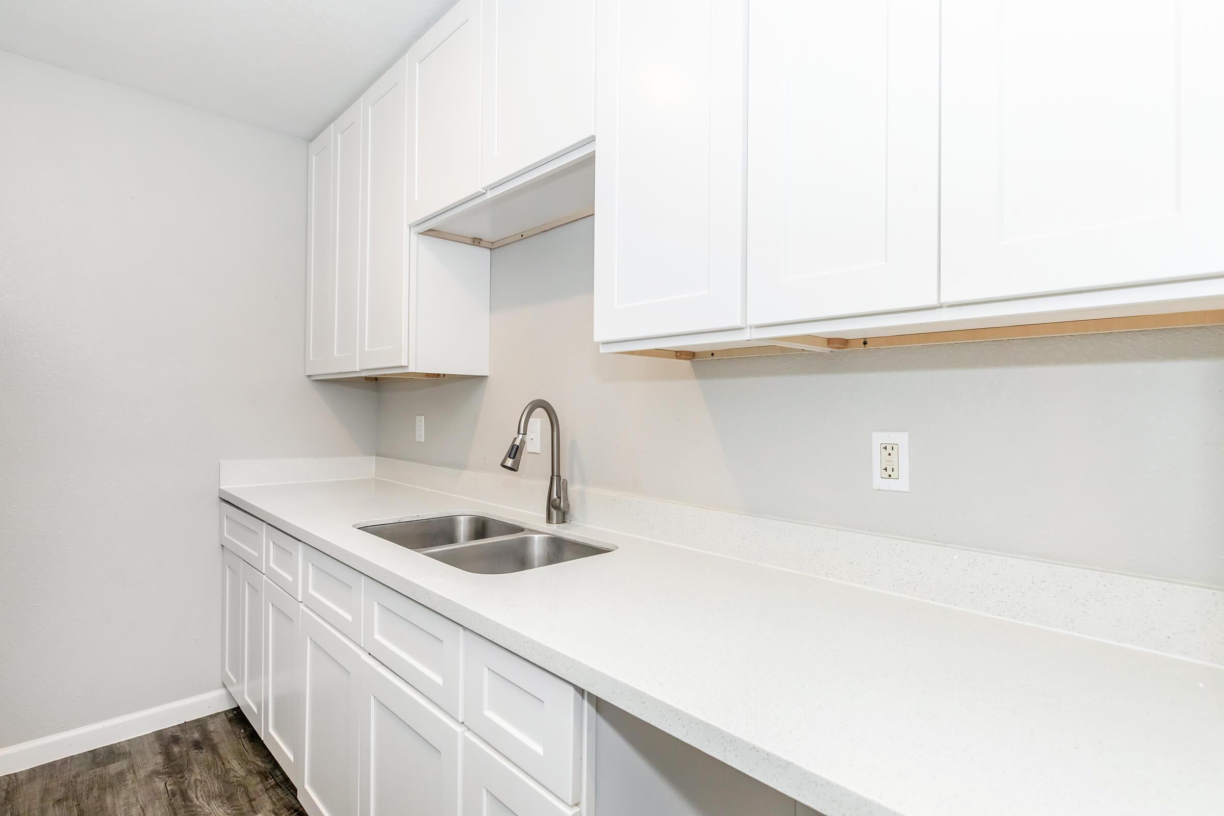 a kitchen with a sink and a mirror