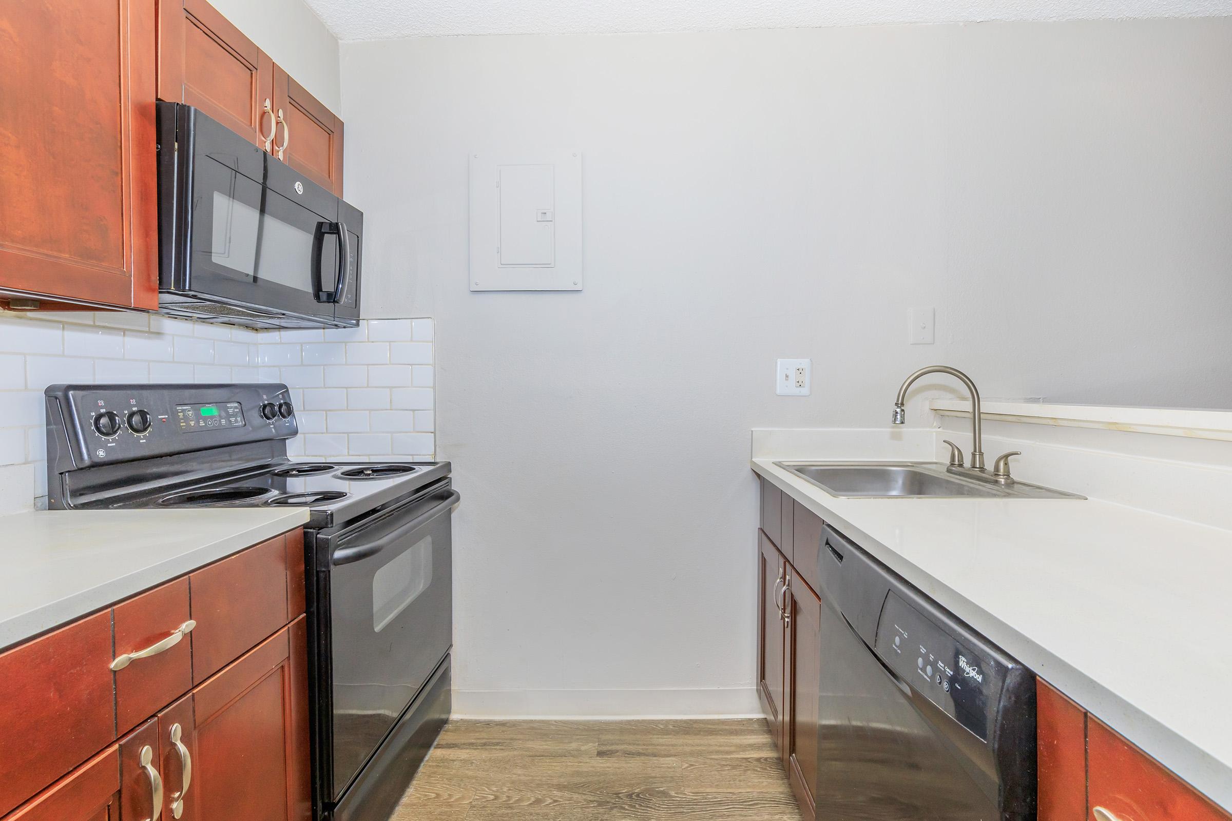 a kitchen with a stove a sink and a microwave