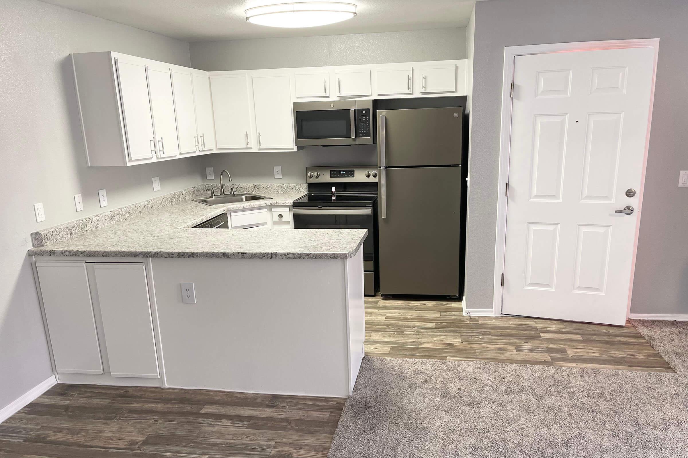 a kitchen with a stove and a refrigerator