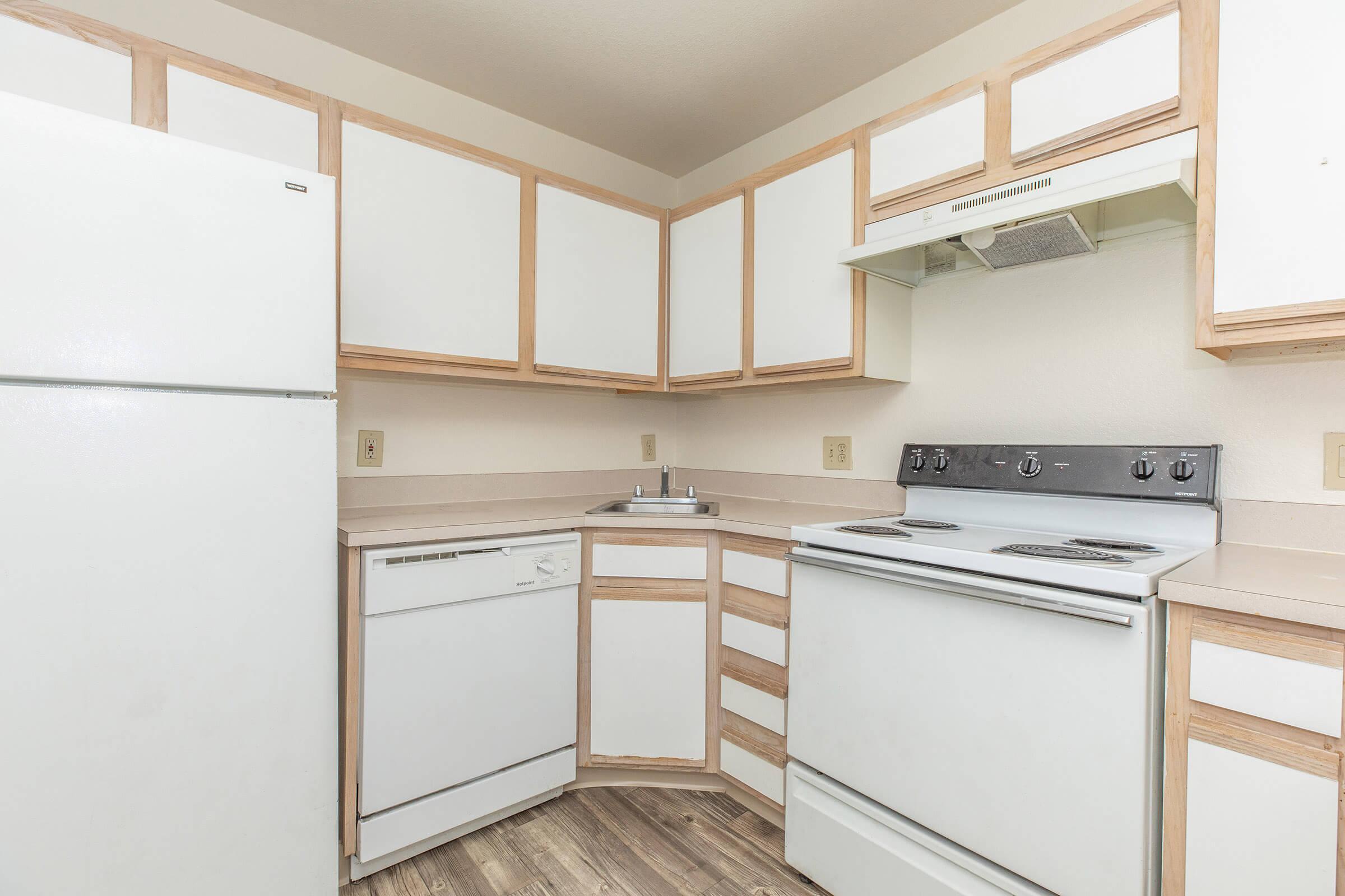 a kitchen with wooden cabinets