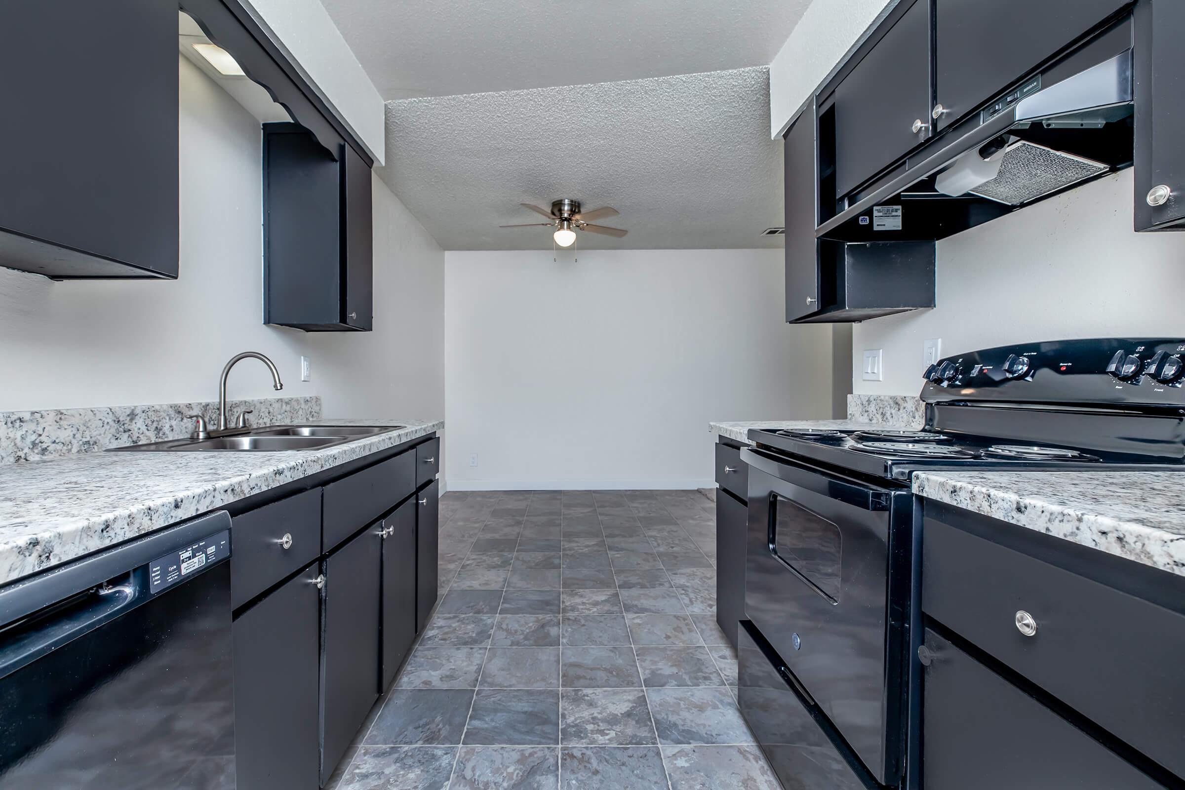 a kitchen with a sink and a mirror