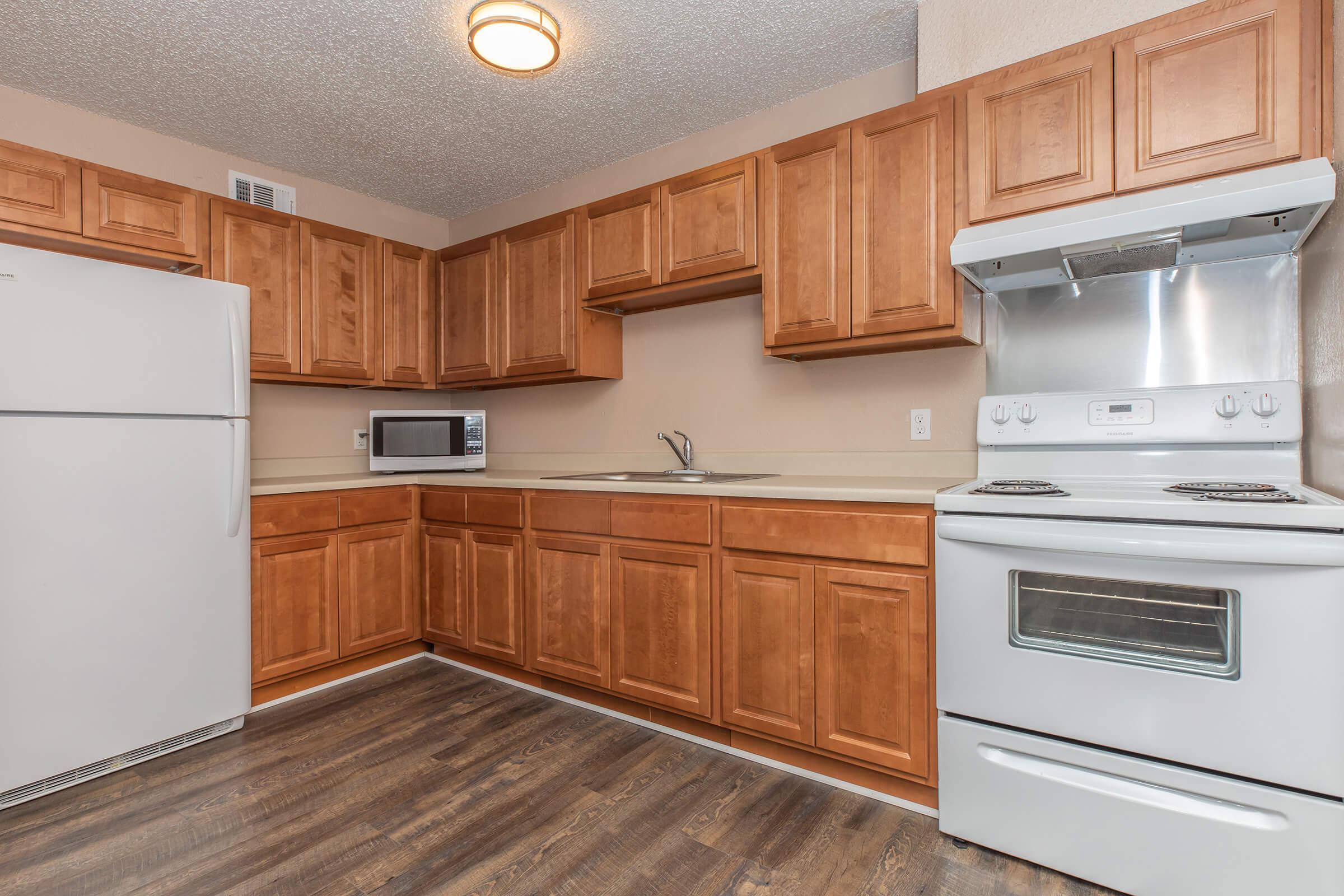 a kitchen with stainless steel appliances and wooden cabinets