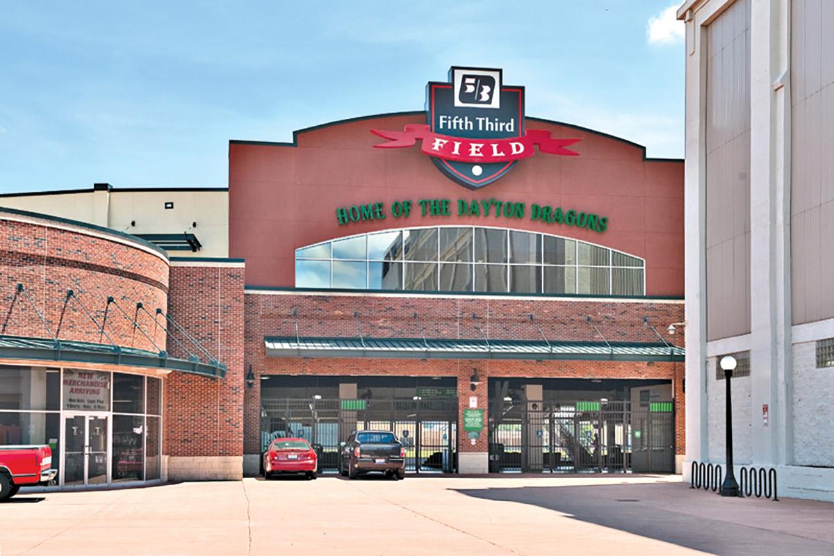 a large brick building with a store on the side of a road