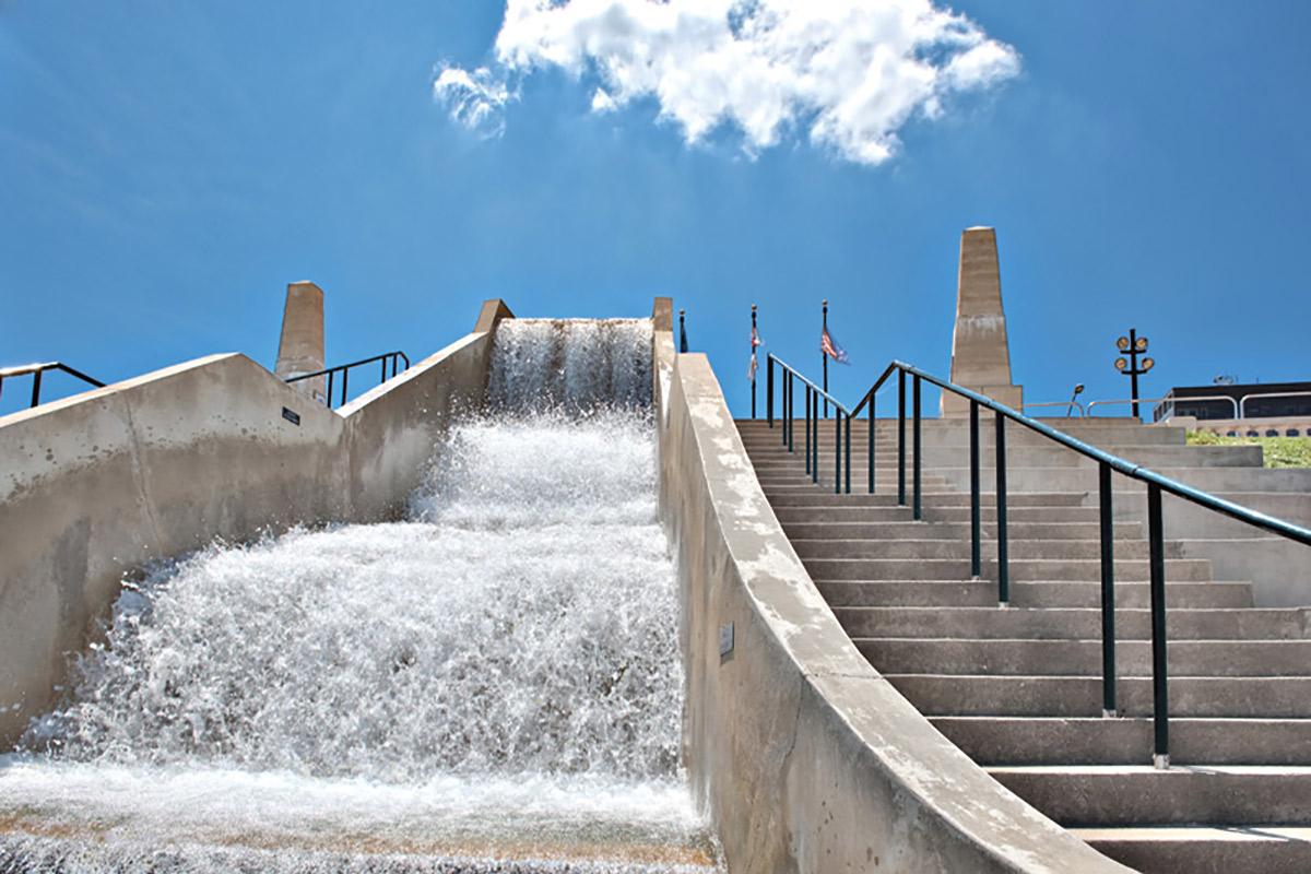 a man riding a wave on top of a ramp