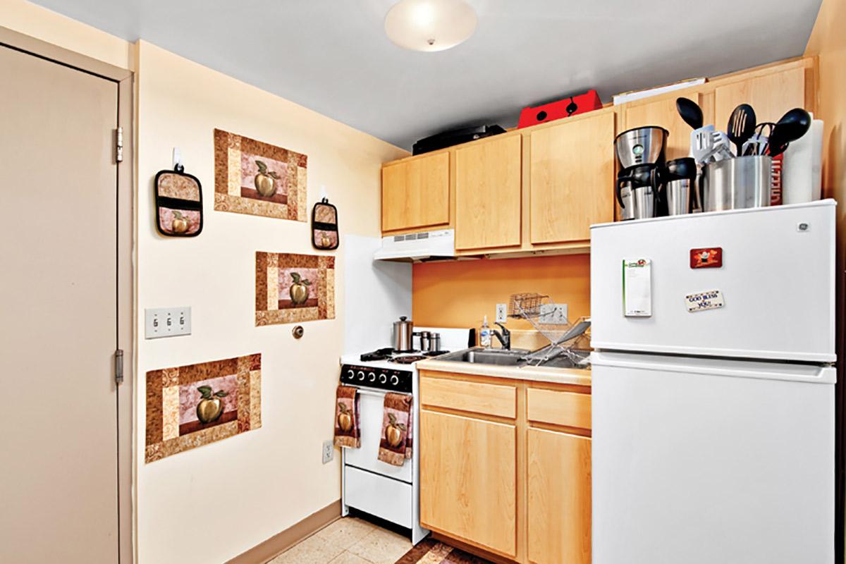 a white refrigerator freezer sitting inside of a kitchen