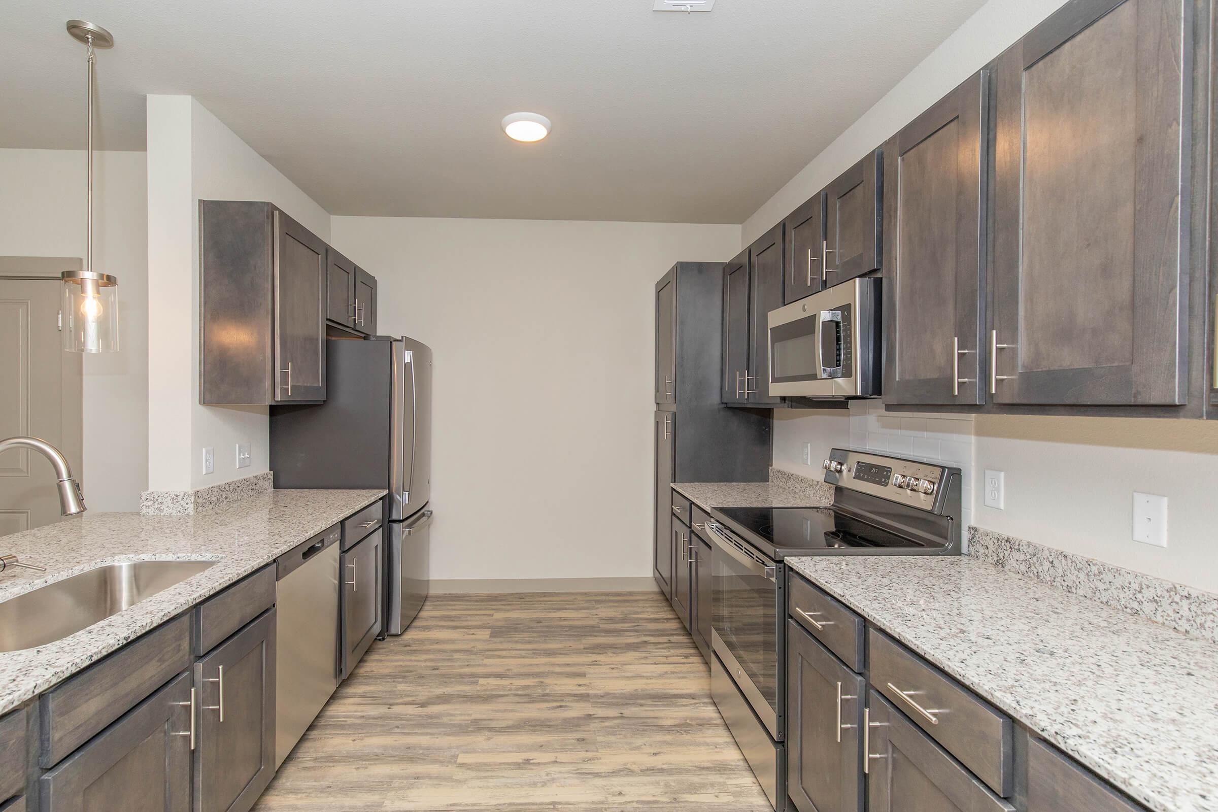 a large kitchen with stainless steel appliances