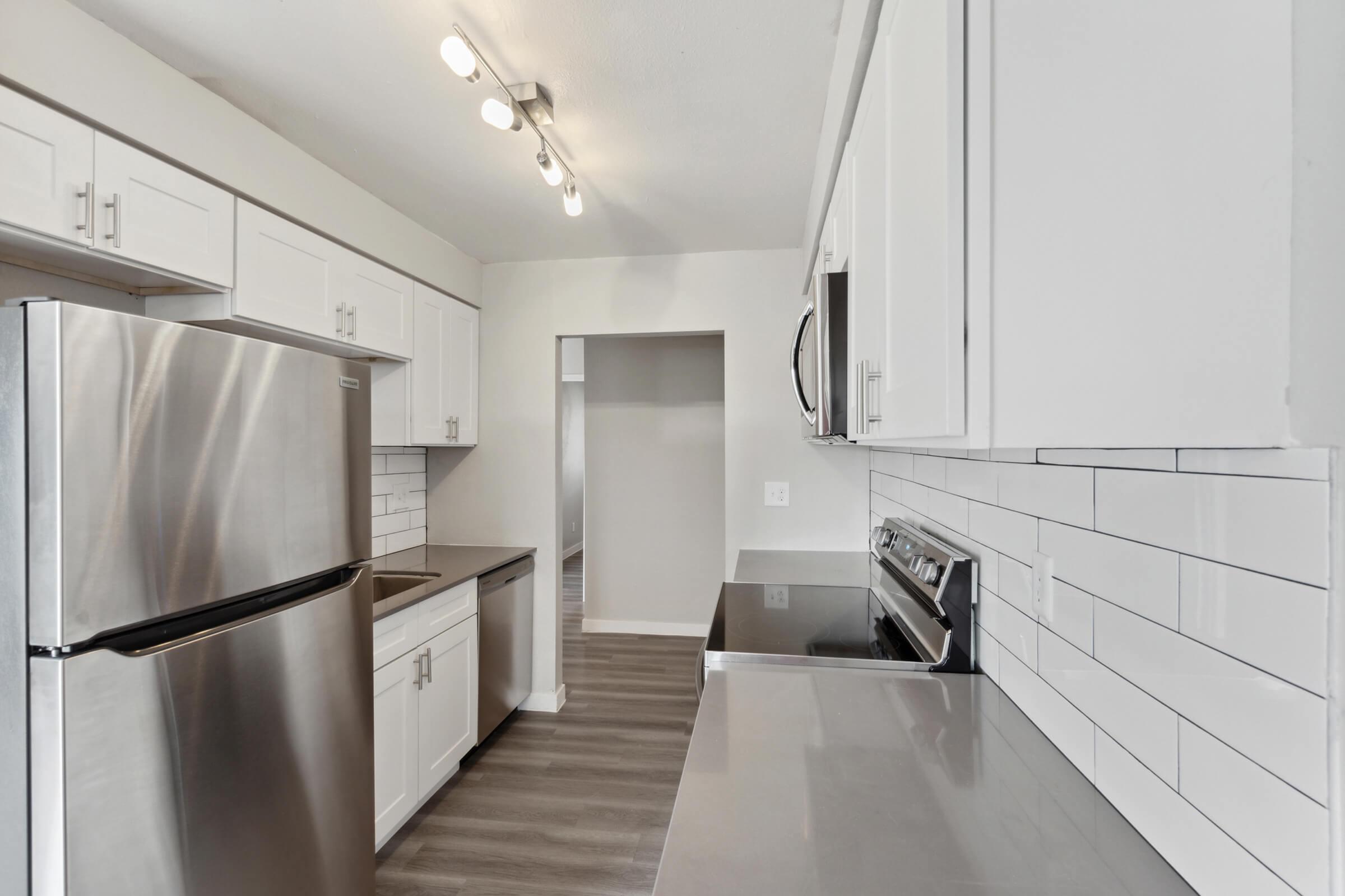a kitchen with a sink and a refrigerator