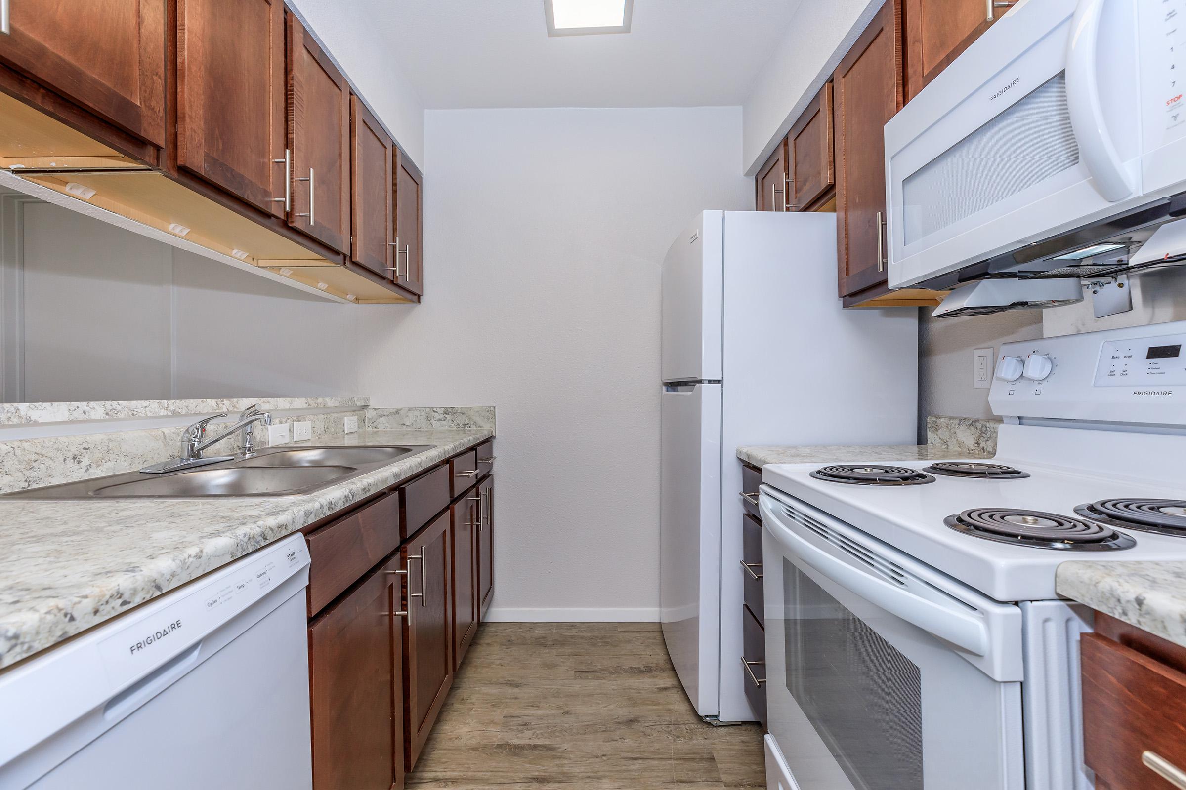 a kitchen with a stove sink and refrigerator