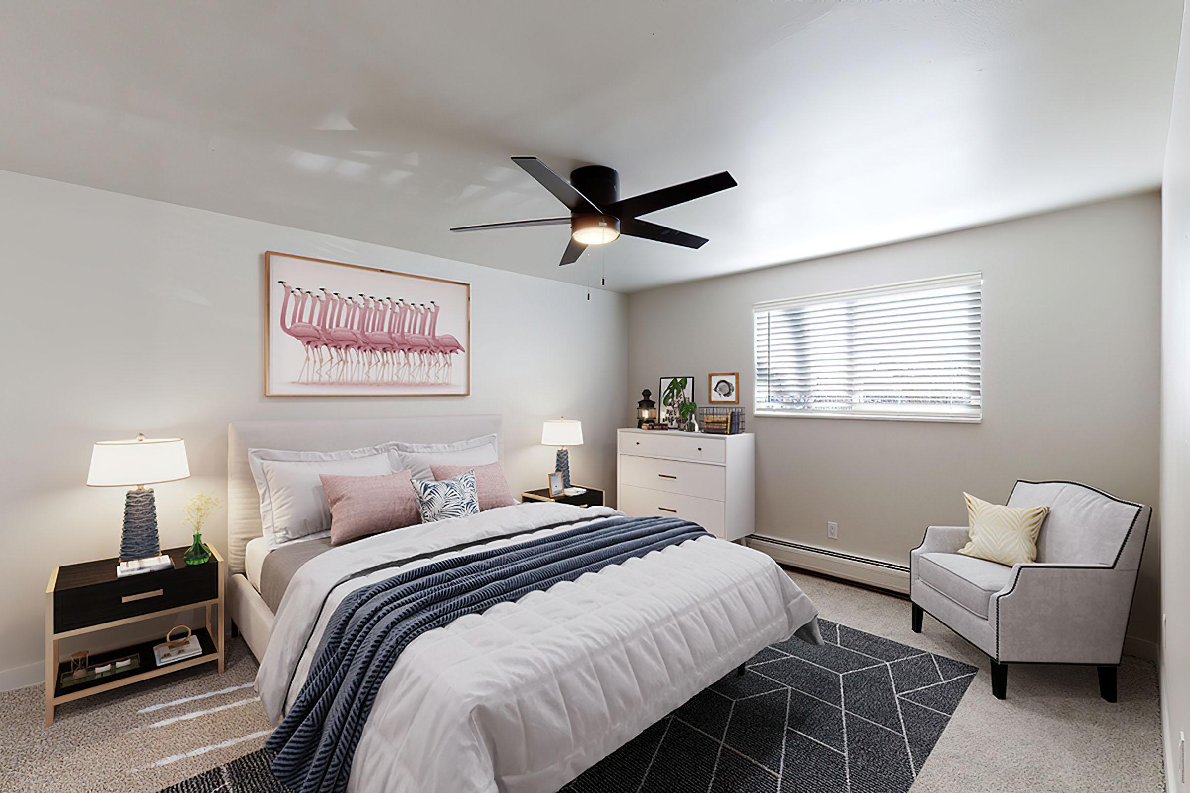 a bedroom with a bed and desk in a hotel room