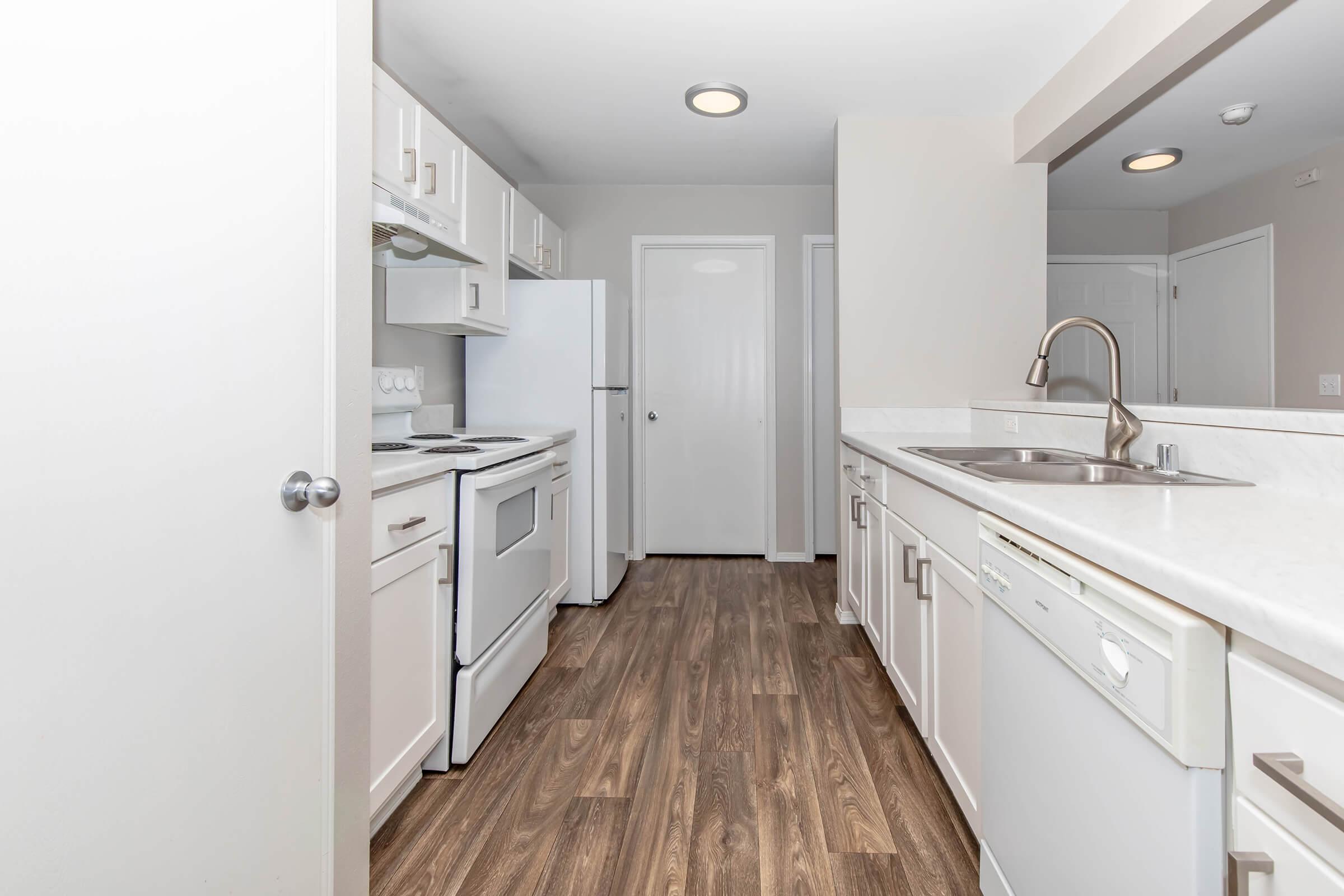 a kitchen with a sink and a mirror