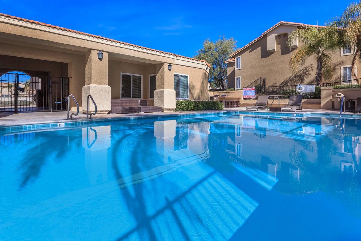 a house with a pool in front of a building