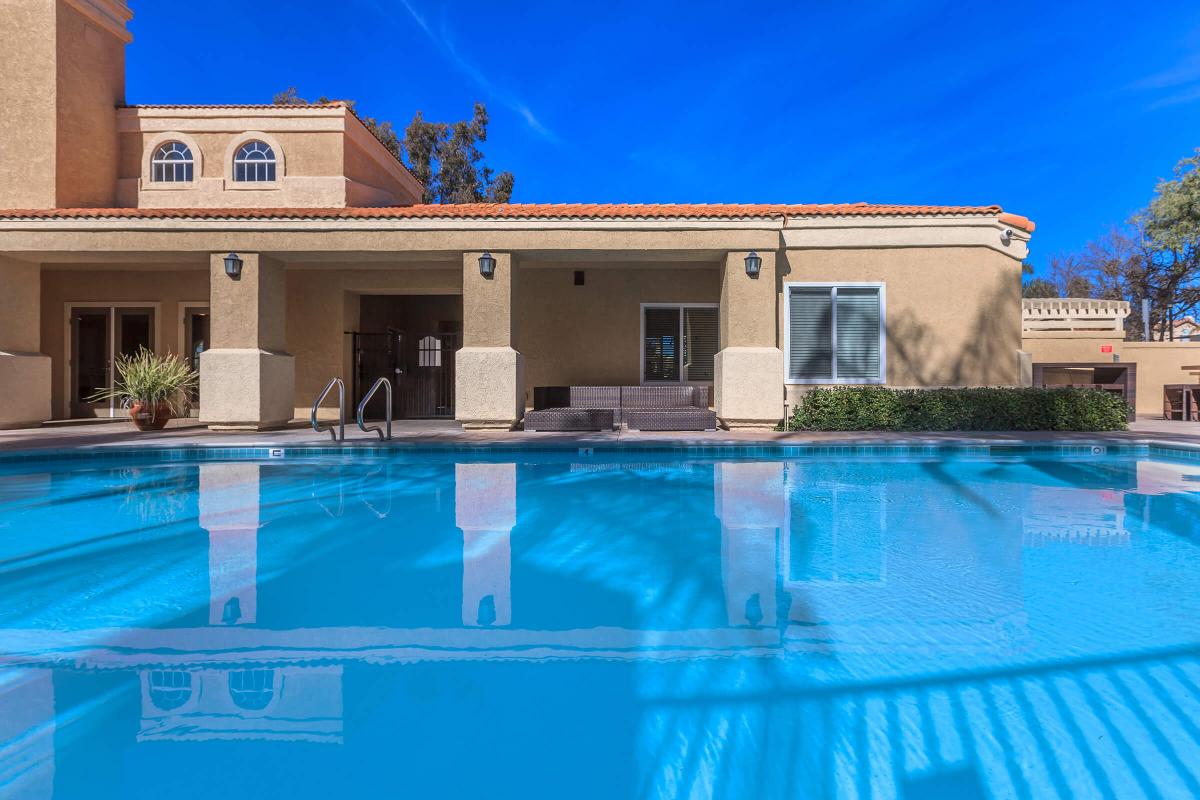 a blue pool of water in front of a building