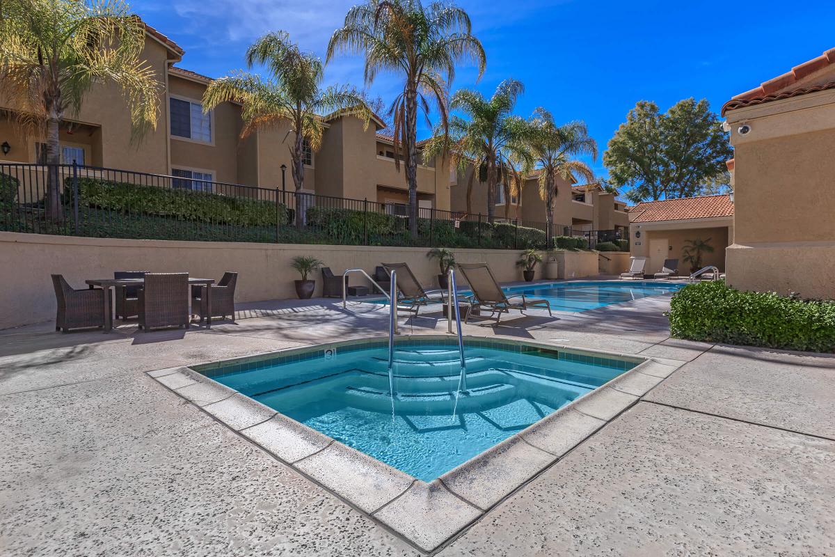 a large brick building with a pool in front of a house