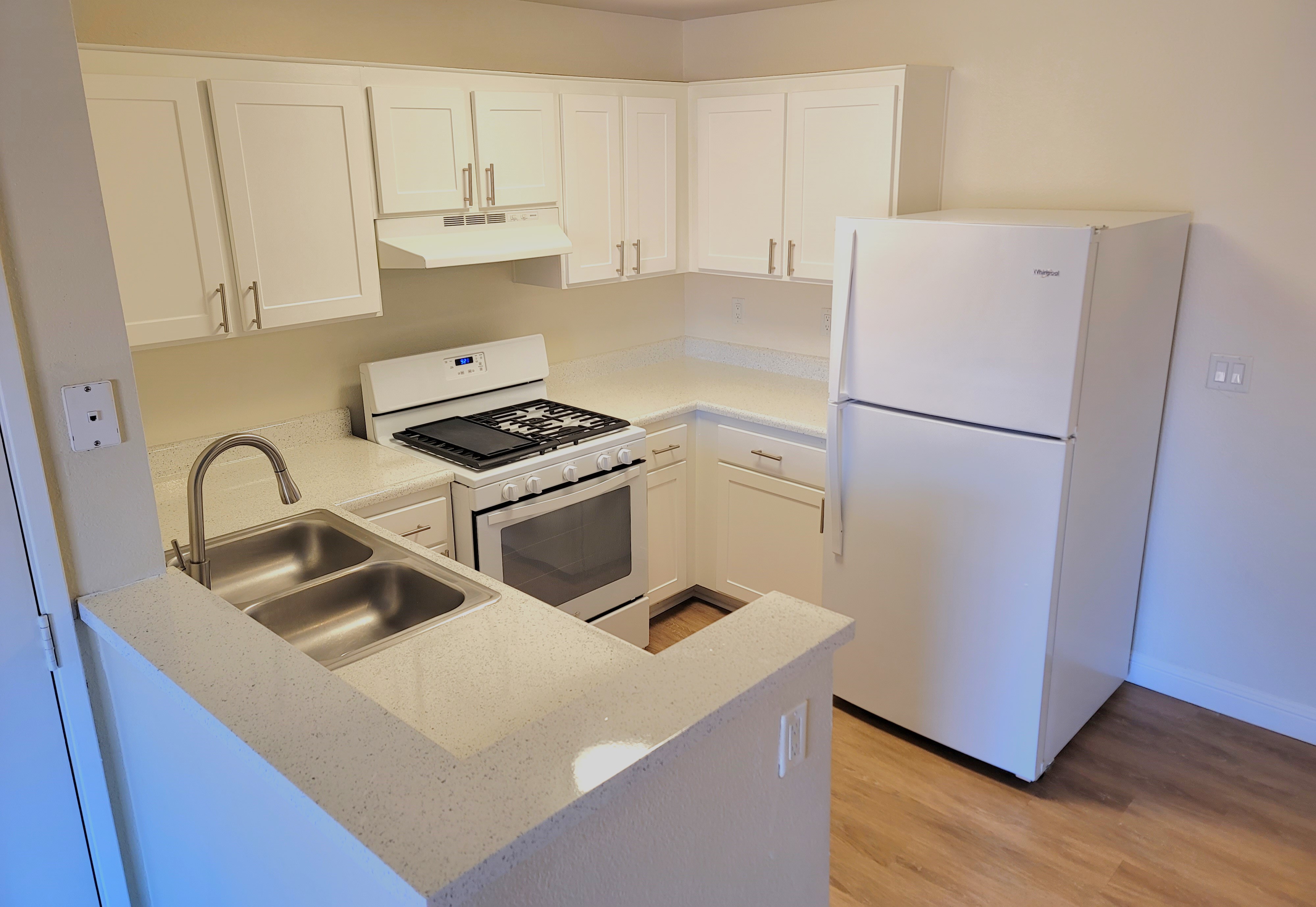 a kitchen with a stove and a refrigerator