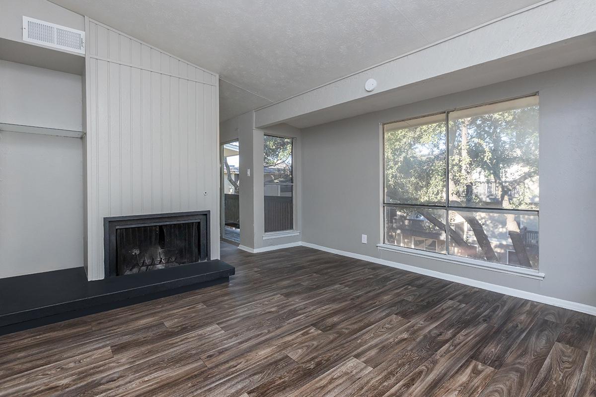 a room with a fireplace and a large window