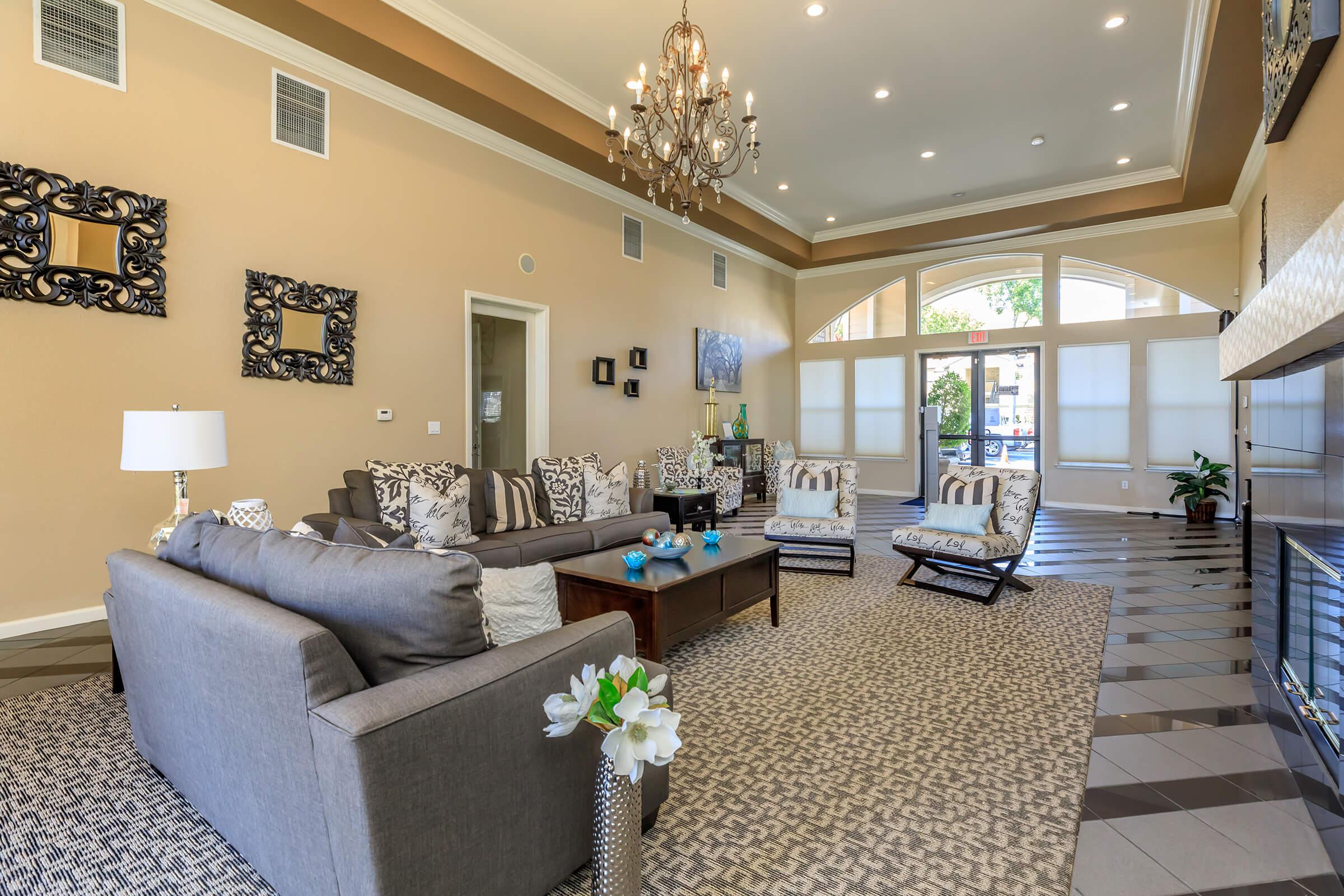 a living room filled with furniture and a large window