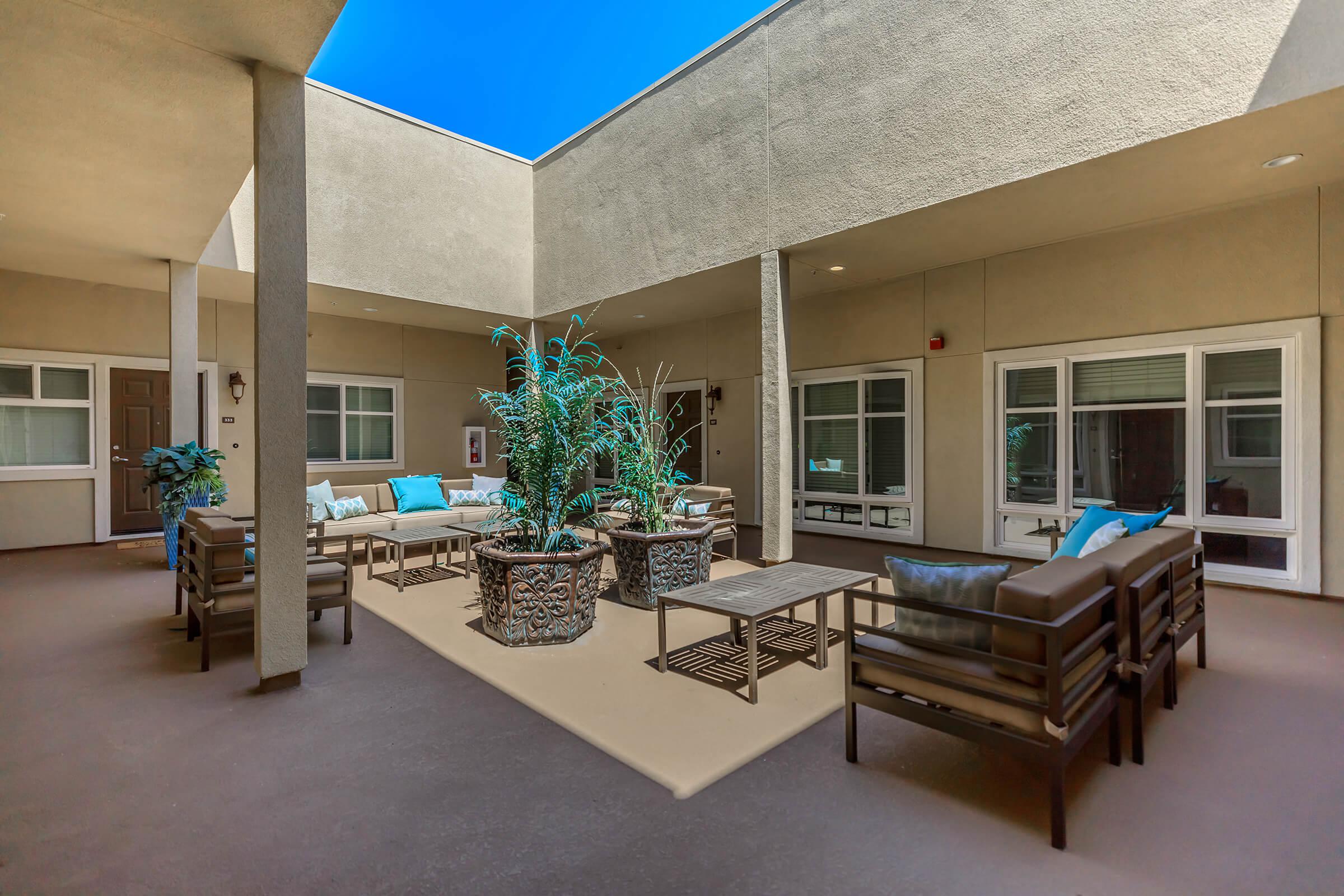 a room filled with furniture and a table in front of a building