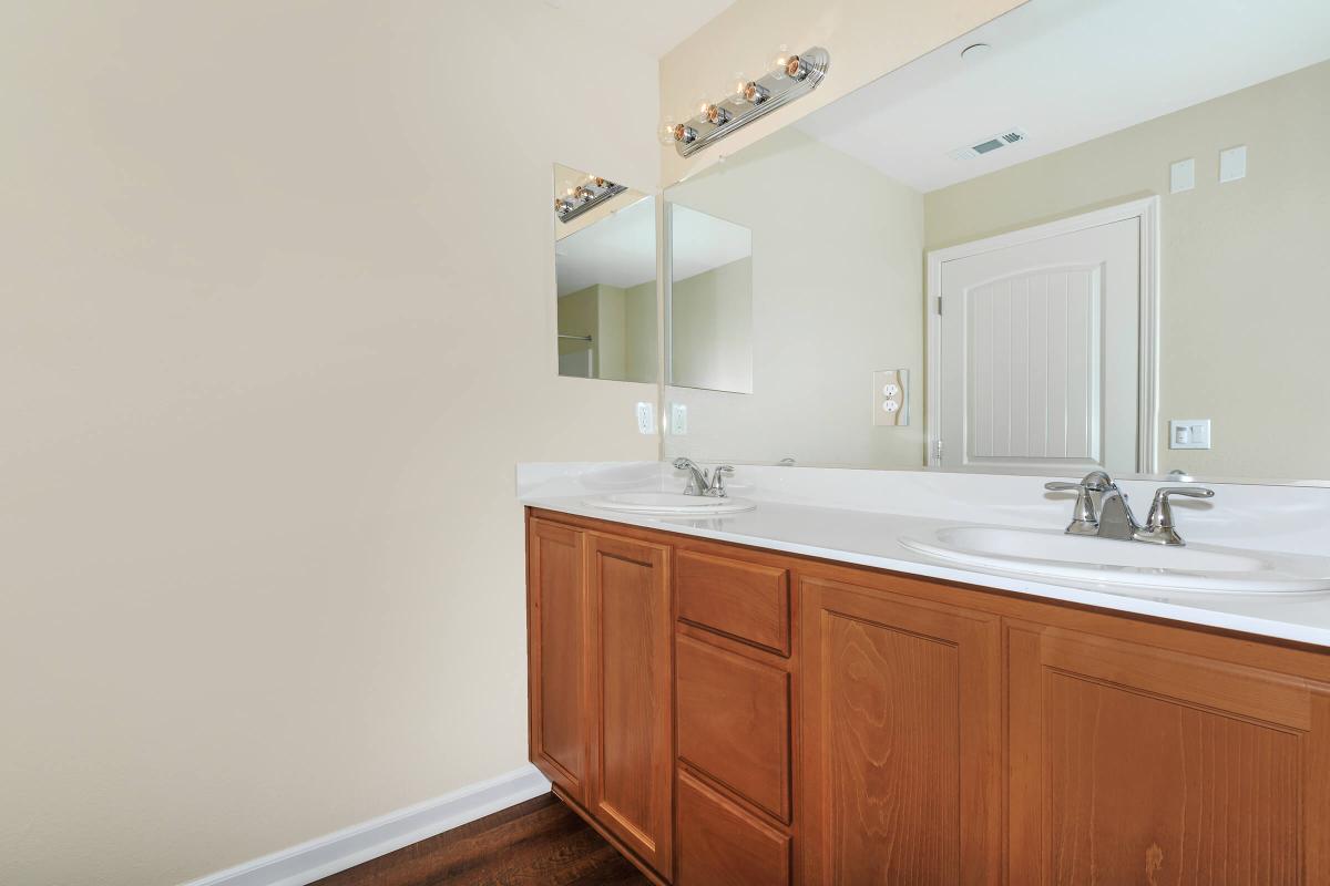 a kitchen with a sink and a mirror