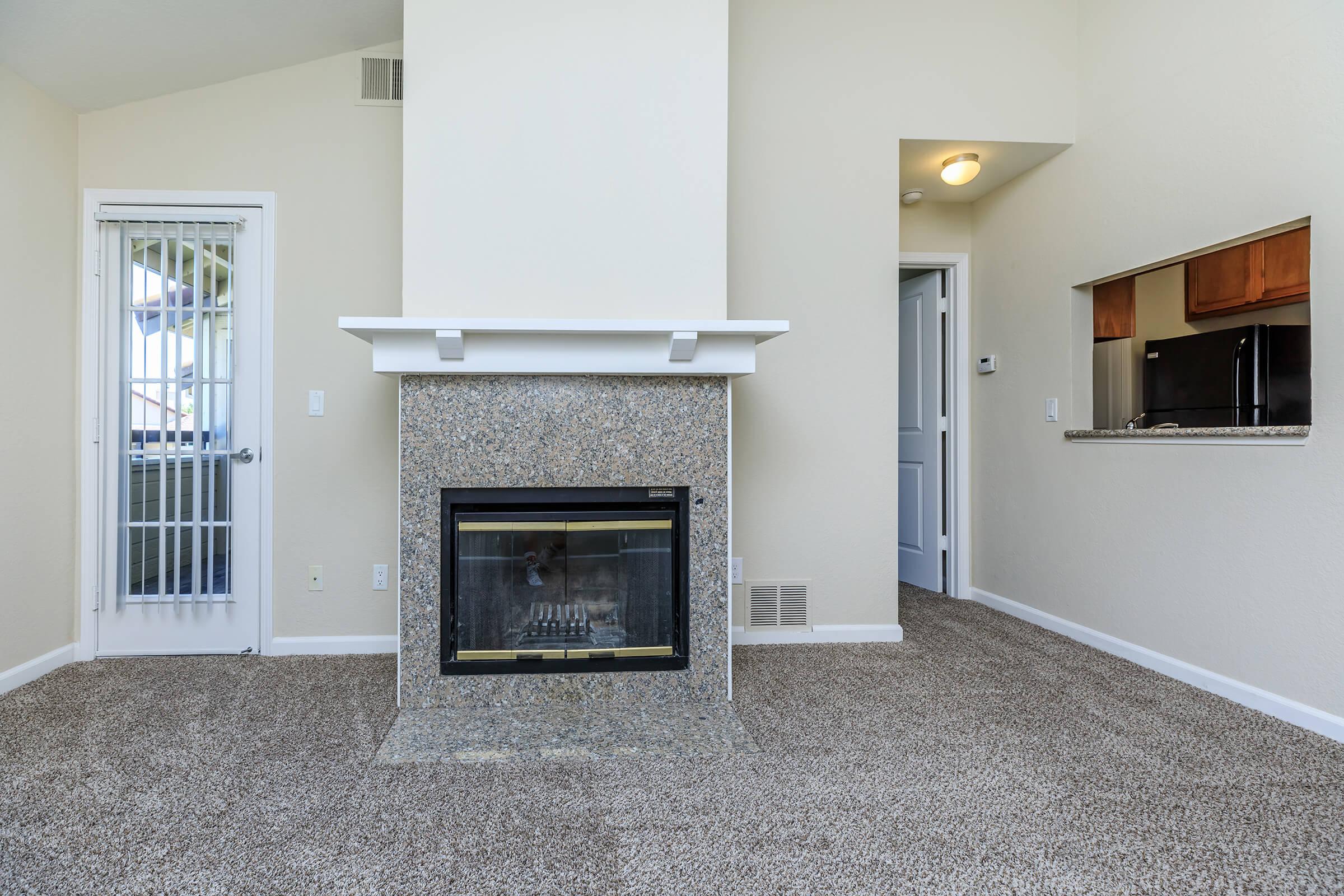 a living room with a fireplace and a large window