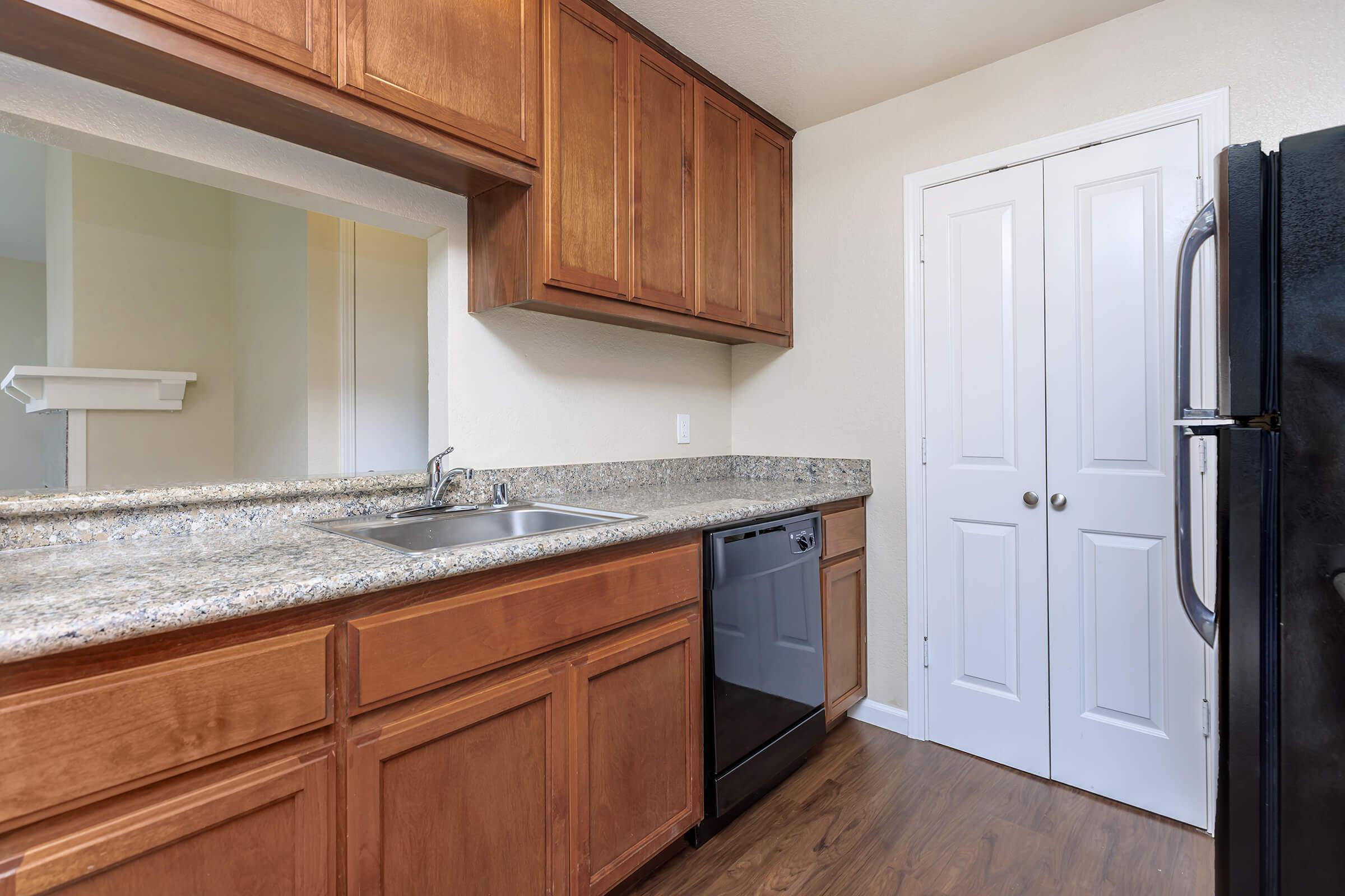 a kitchen with stainless steel appliances and wooden cabinets