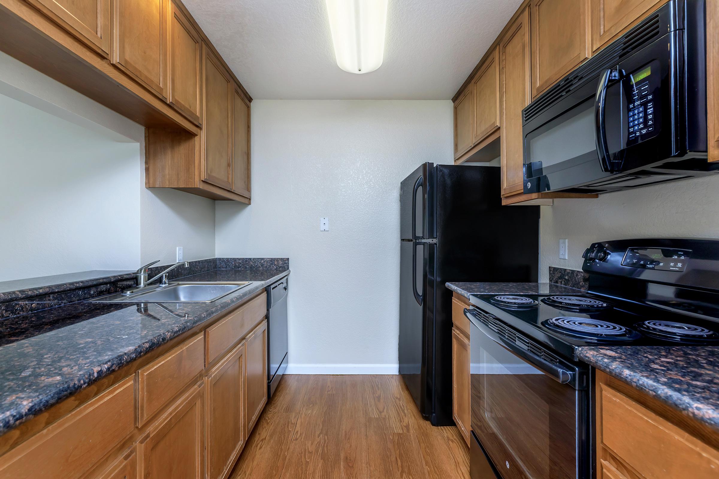 a modern kitchen with stainless steel appliances and wooden cabinets