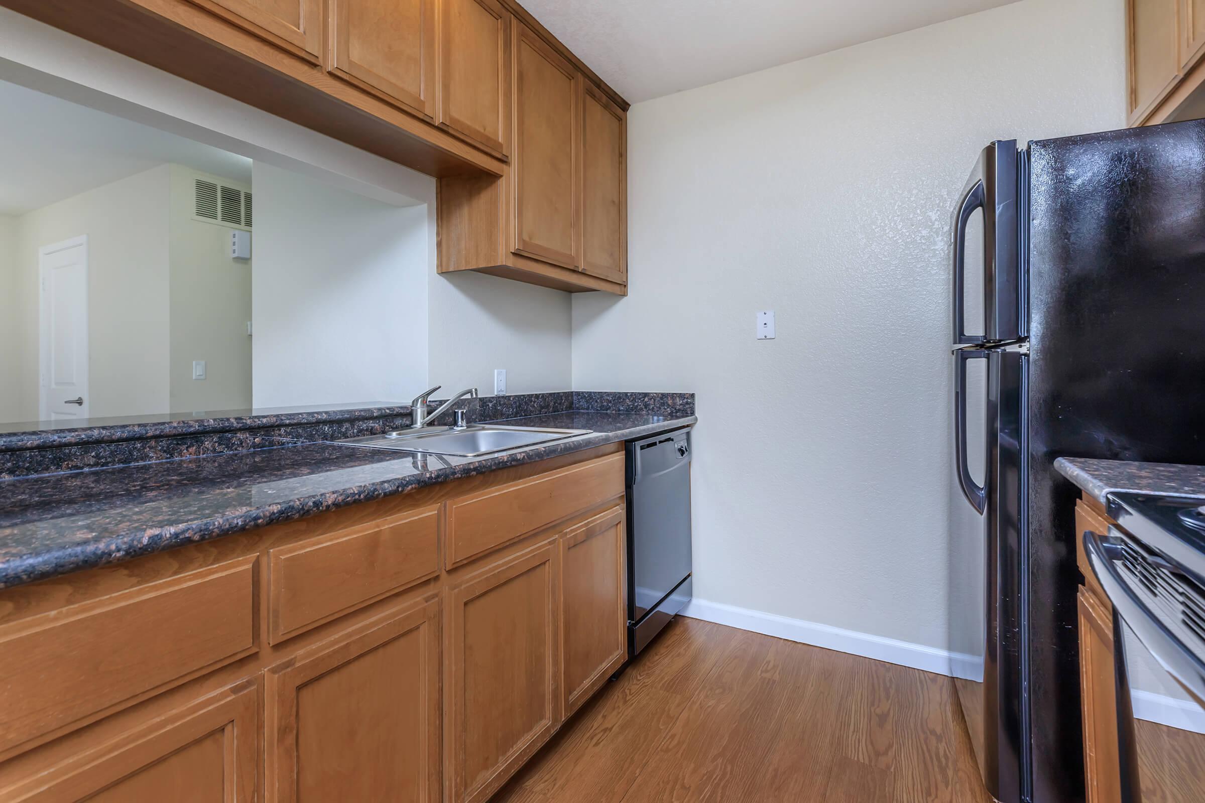 a kitchen with stainless steel appliances and wooden cabinets