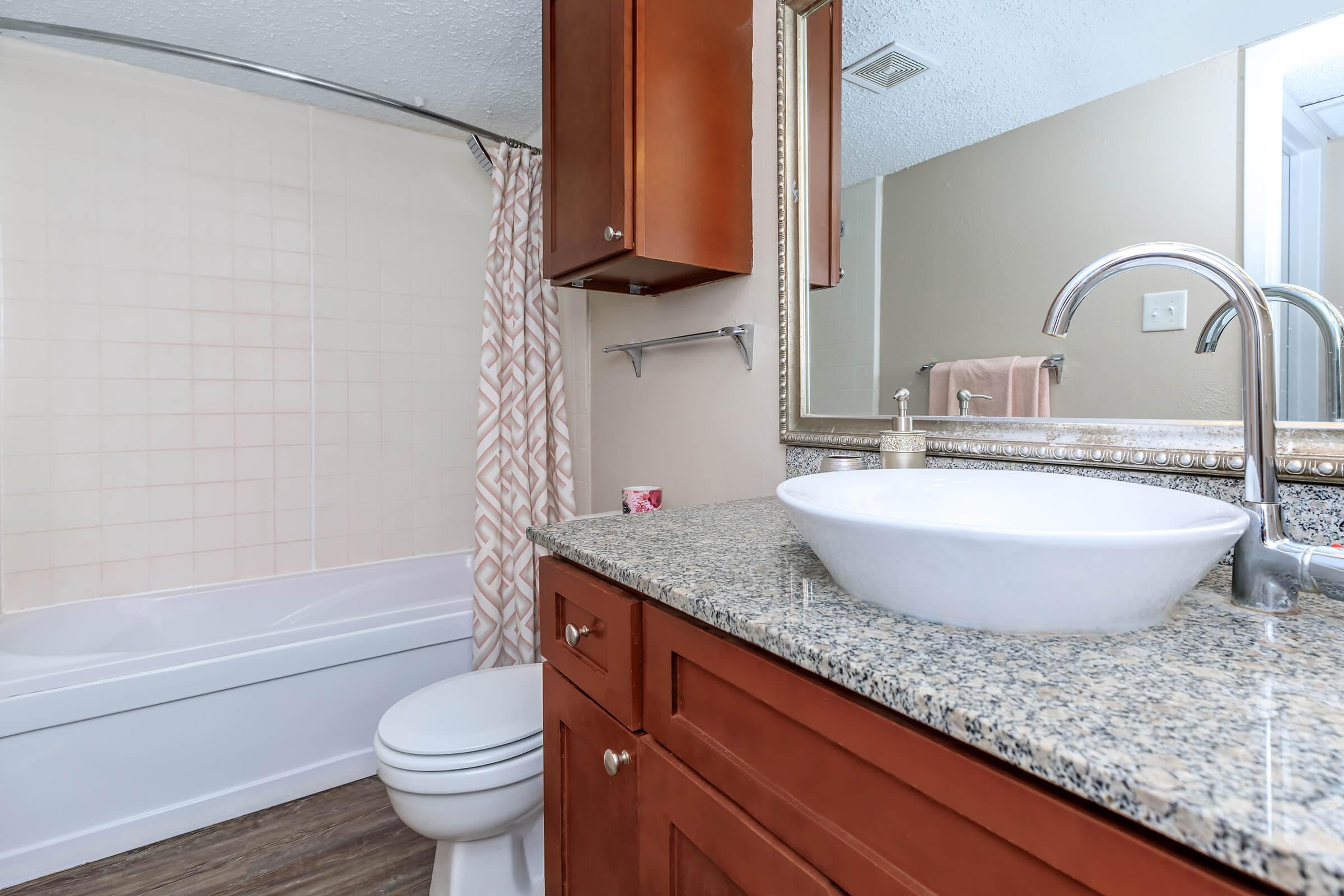 a kitchen with a sink and a mirror