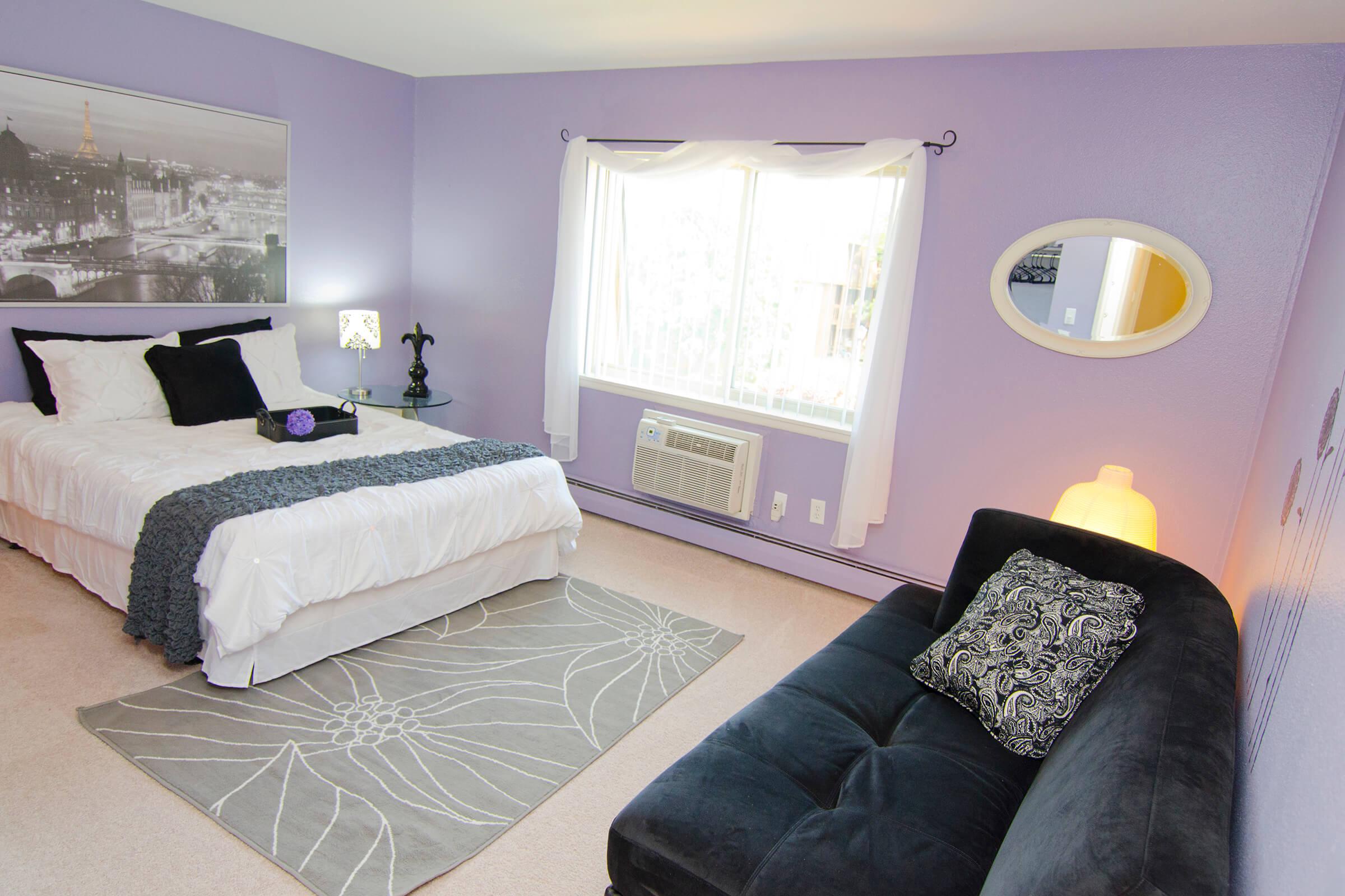 a bedroom with a view of a living room