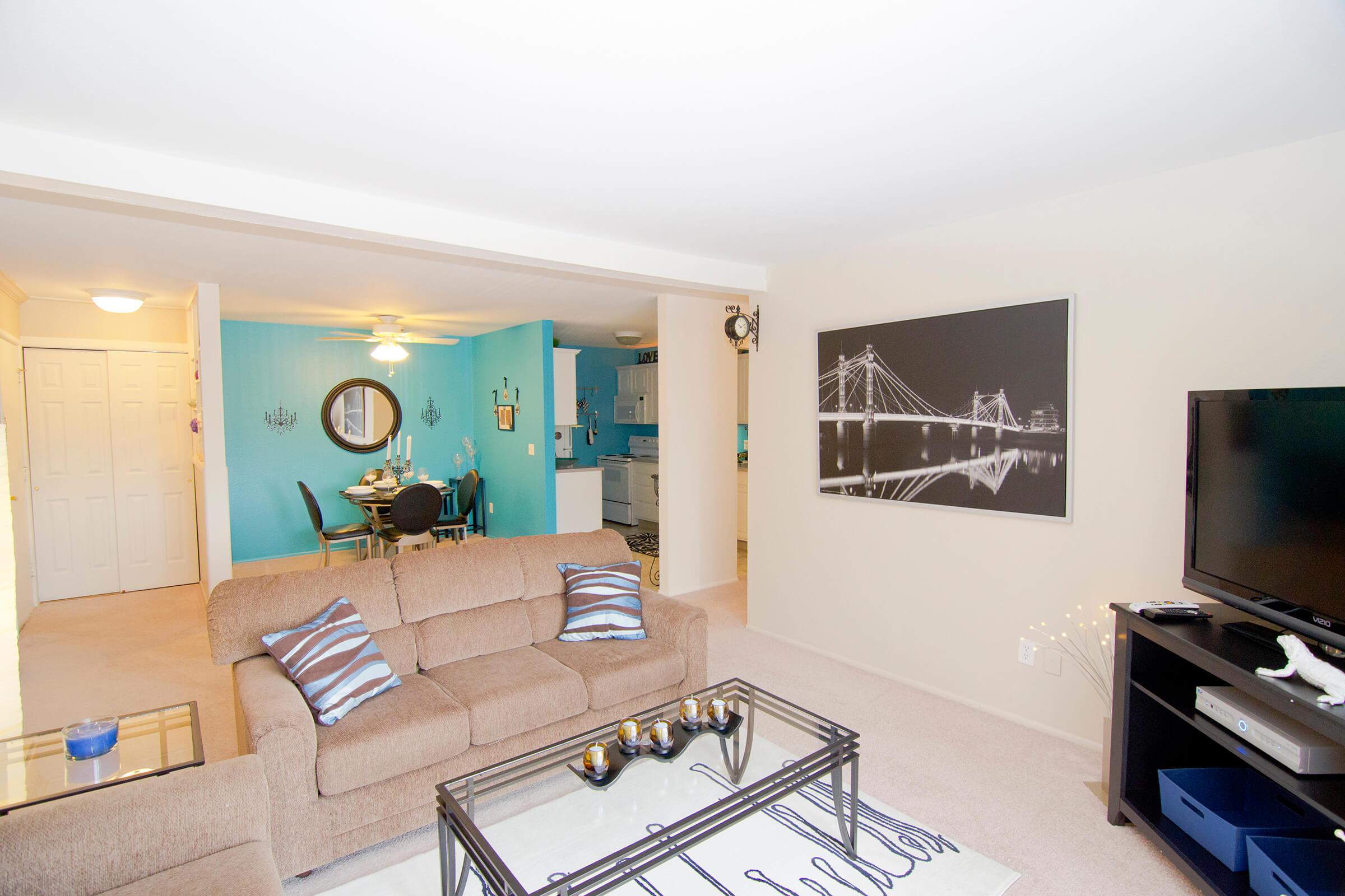 a living room filled with furniture and a flat screen tv