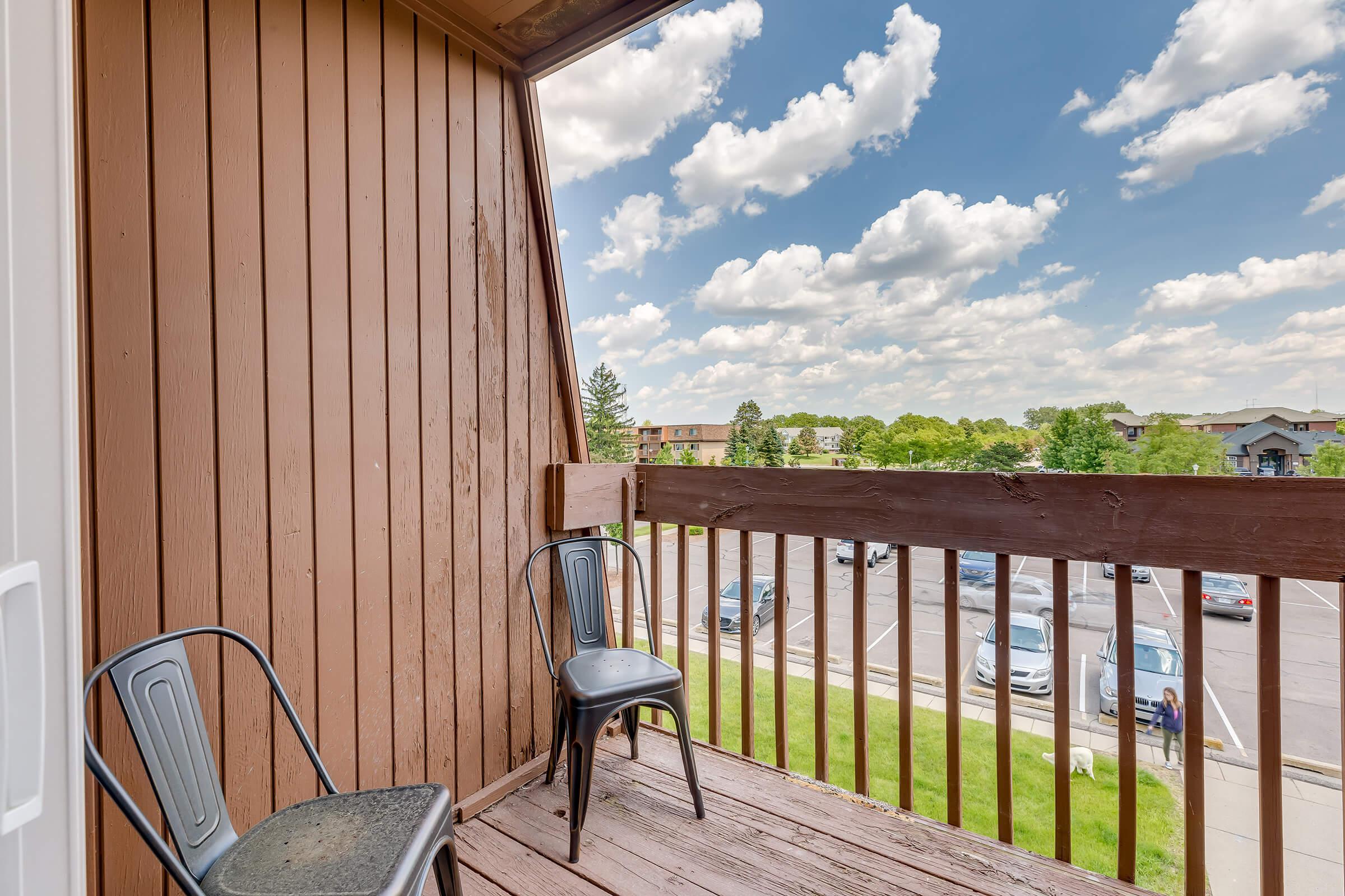 a chair sitting in front of a wooden fence